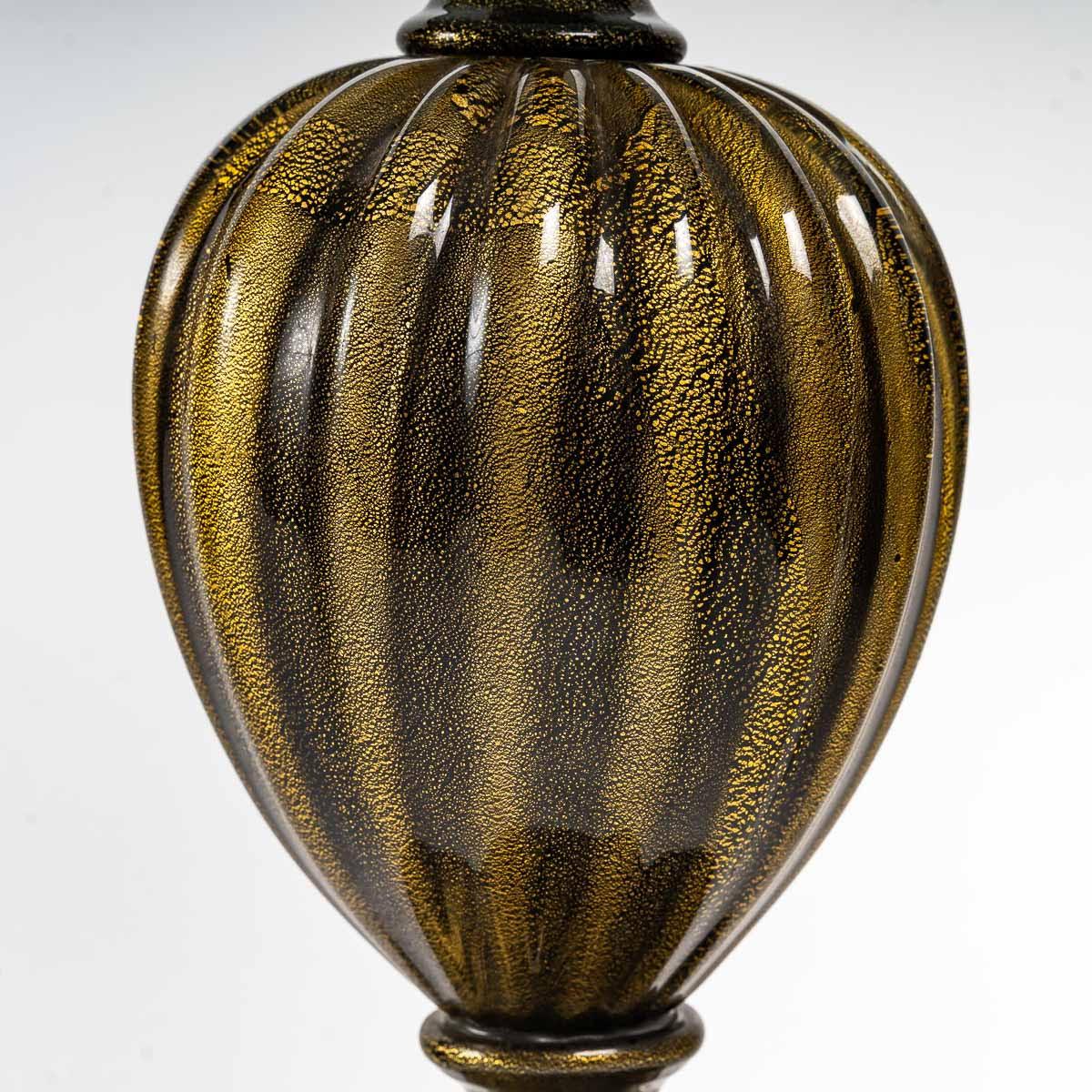 Paire de lampes de table en verre de Murano, Italie, 1950.

Paire de lampes de table balustres en verre de Murano noir et or, Italie, 1950.
Lampes : H : 45cm, D : 22.5cm
Avec abat-jour : H : 69cm, D : 46cm