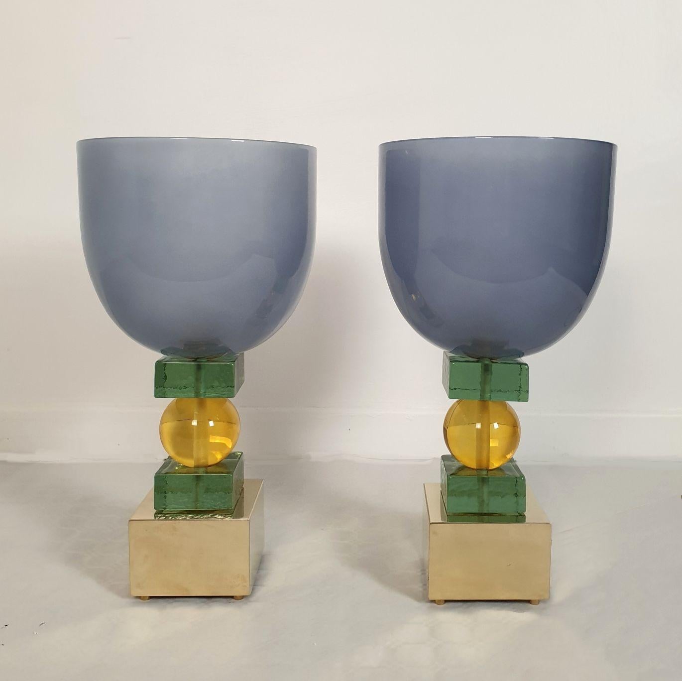 Large Mid Century Modern Murano glass table lamps, Italy 1980s. A pair.
Italian Memphis style lighting. Can be used as desk lamps.
The pair of lamps is colorful: a blue-gray top vase nesting the light, olive-green and yellow-amber central parts on a