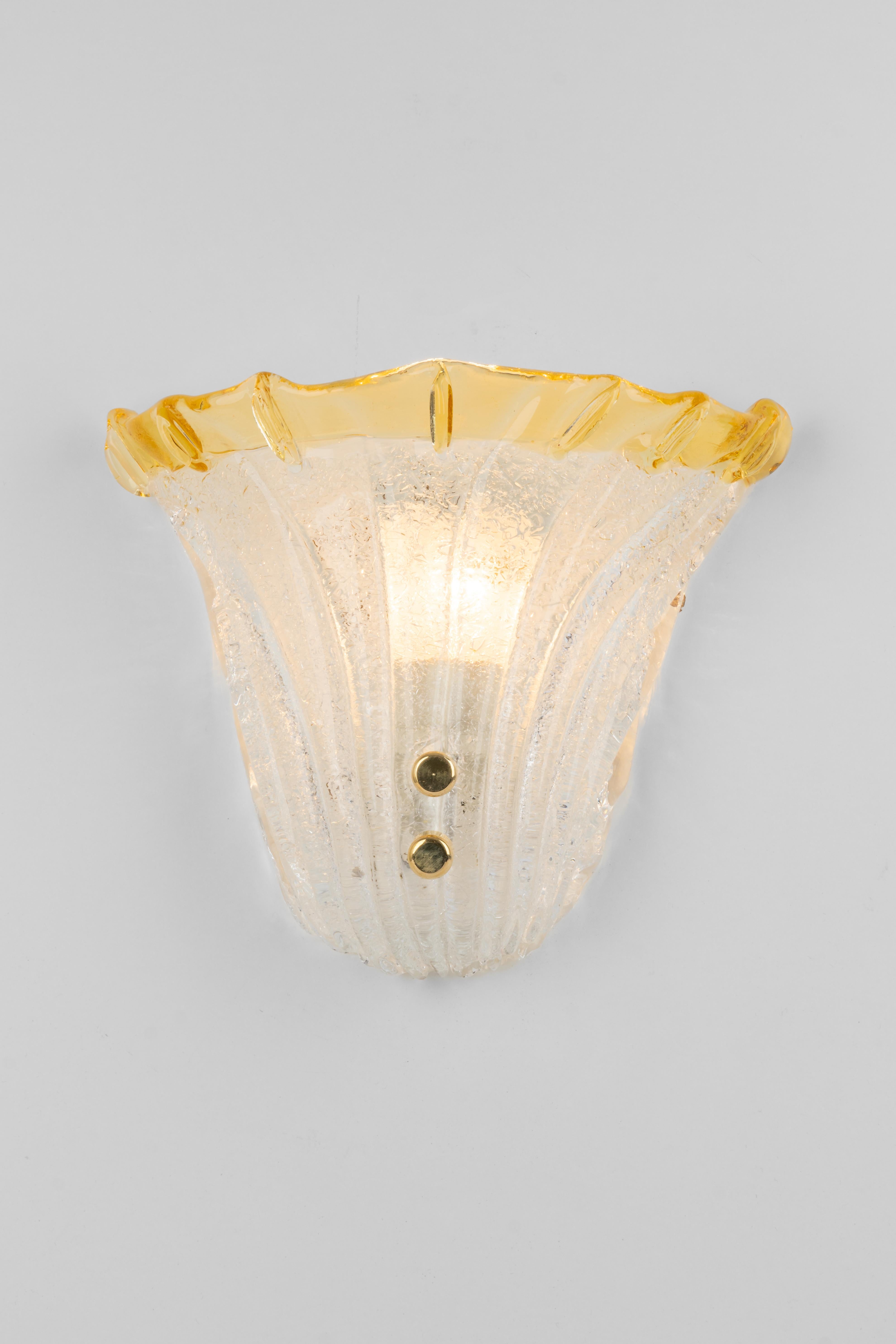 Pair of beautiful wall lights with Murano glass in Venini style, Italy. Manufactured circa 1970s.
Very good quality and condition. Cleaned, well-wired and ready to use. 

Each fixture requires 1 small bulb (E-14) / up to 60 W
Light bulbs are not