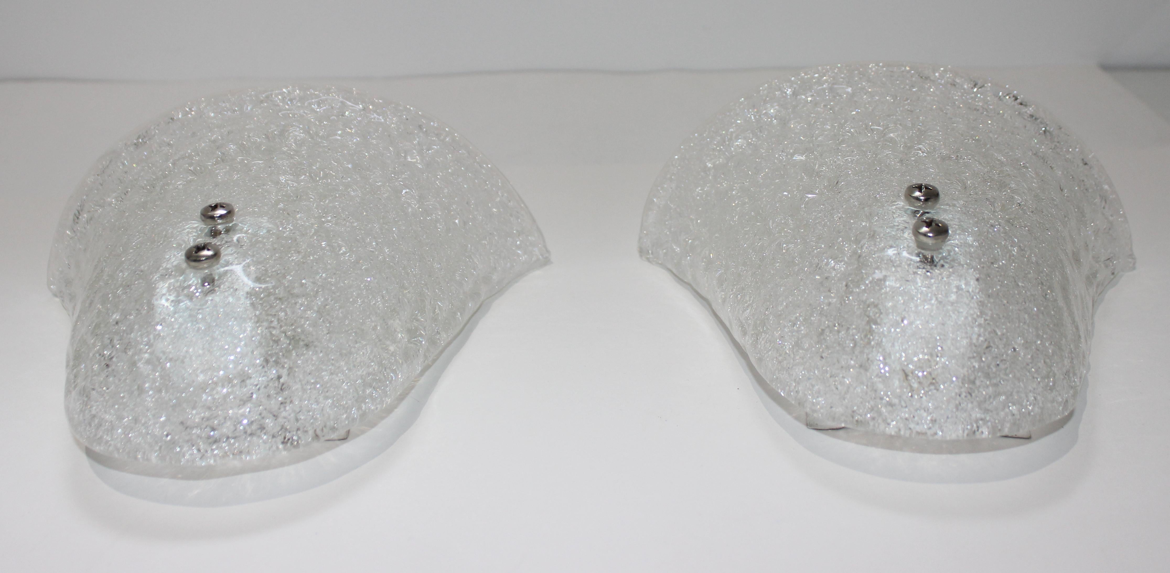 This stylish pair of Murano glass wall sconces date to the 1970s.

Note: They can be hung either way, up or down (see last image).

Note: Because these are handmade, there is slight variation in size, for example, the width varies from 8.5