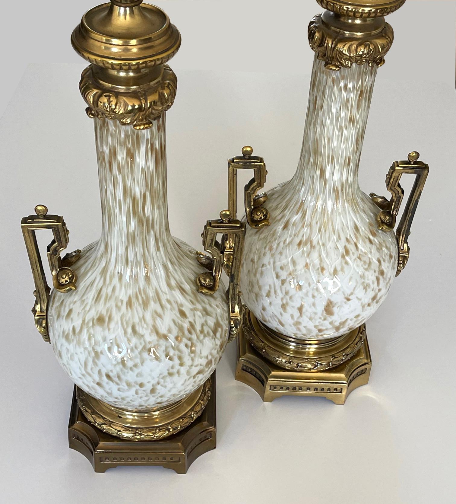 the white bottle-form Murano lamp with gold inclusions fitted with brass mounts.