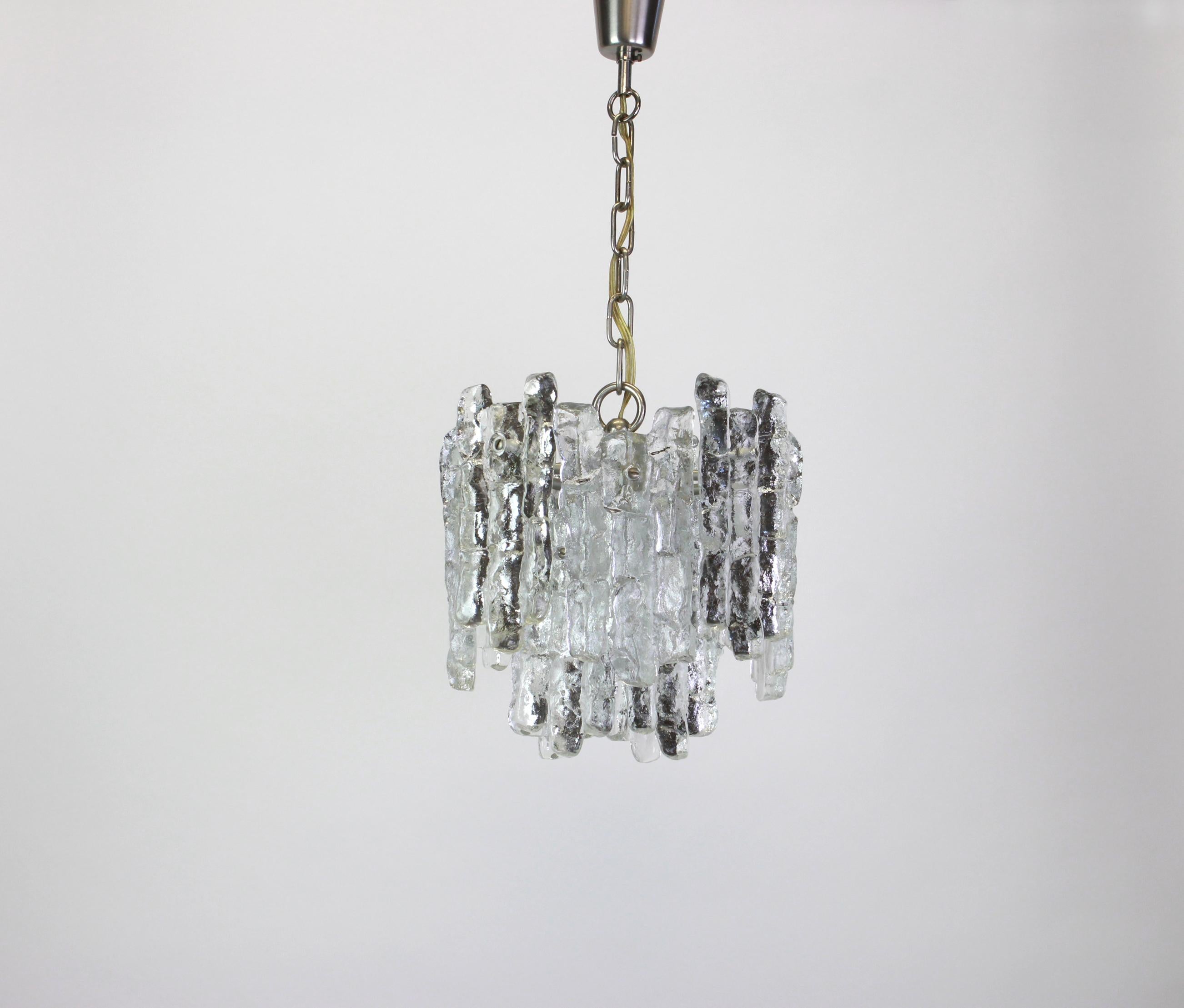 Stunning pair of Murano glass pendants by Kalmar, 1960s
Two tiers structure gathering 12 structured glasses, beautifully refracting the light very heavy quality.

Heavy quality and in very good condition. Cleaned, well-wired and ready to use. 

The