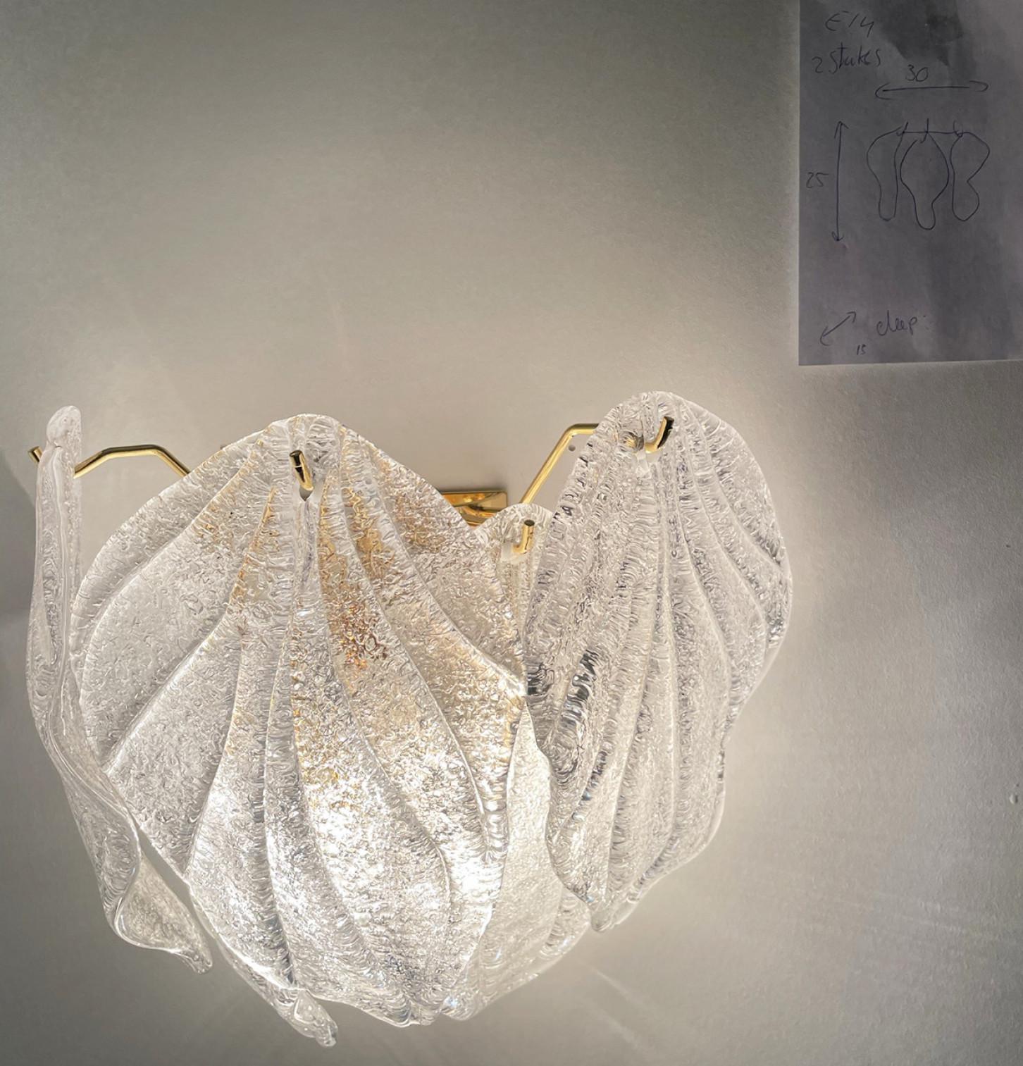A pair of  three-light Murano wall lights with layers of leaf form hand blown hanging glass with brass frame.

Cleaned well wired and ready to use. In excellent vintage condition. Each wall lights requires 3 X E14 light bulbs up to 40 watt.

Also a