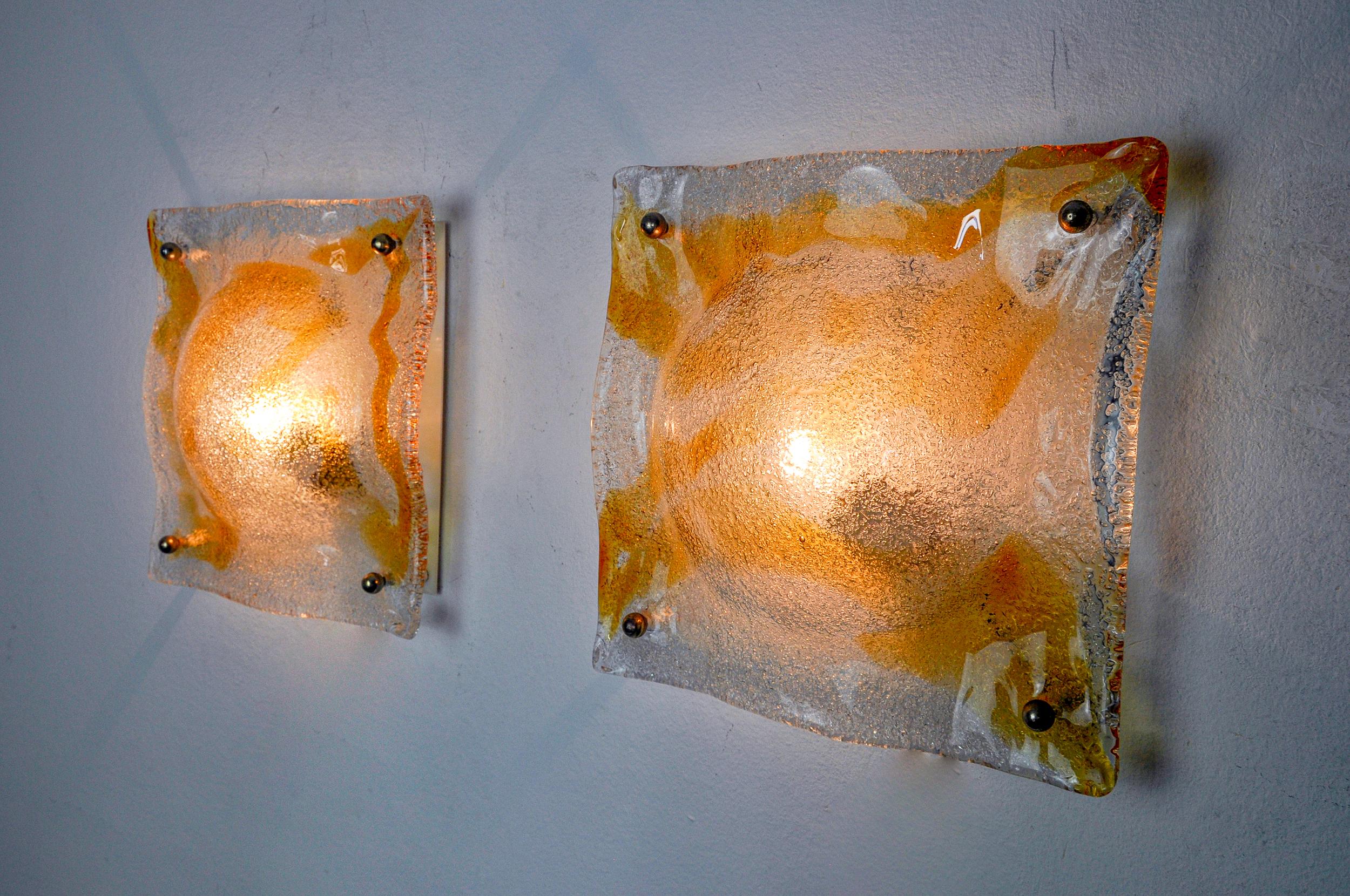 Superb pair of orange wall lights produced by Murano Mazzega in Italy in the 70s. Murano glass crystals and white metal structure. Rare design object that will illuminate your interior wonderfully. Electricity checked, hidden wiring, easy