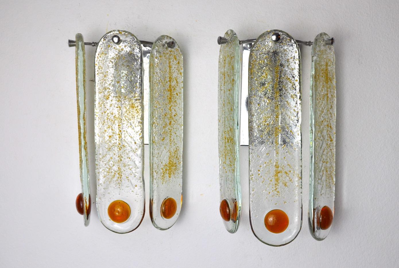 Very nice pair of mazzega sconces designed and produced in murano, italy in the 60s. This magnificent pair of sconces is made of orange frosted murano glass, suspended from a silver metal structure. Rare design object that will illuminate your