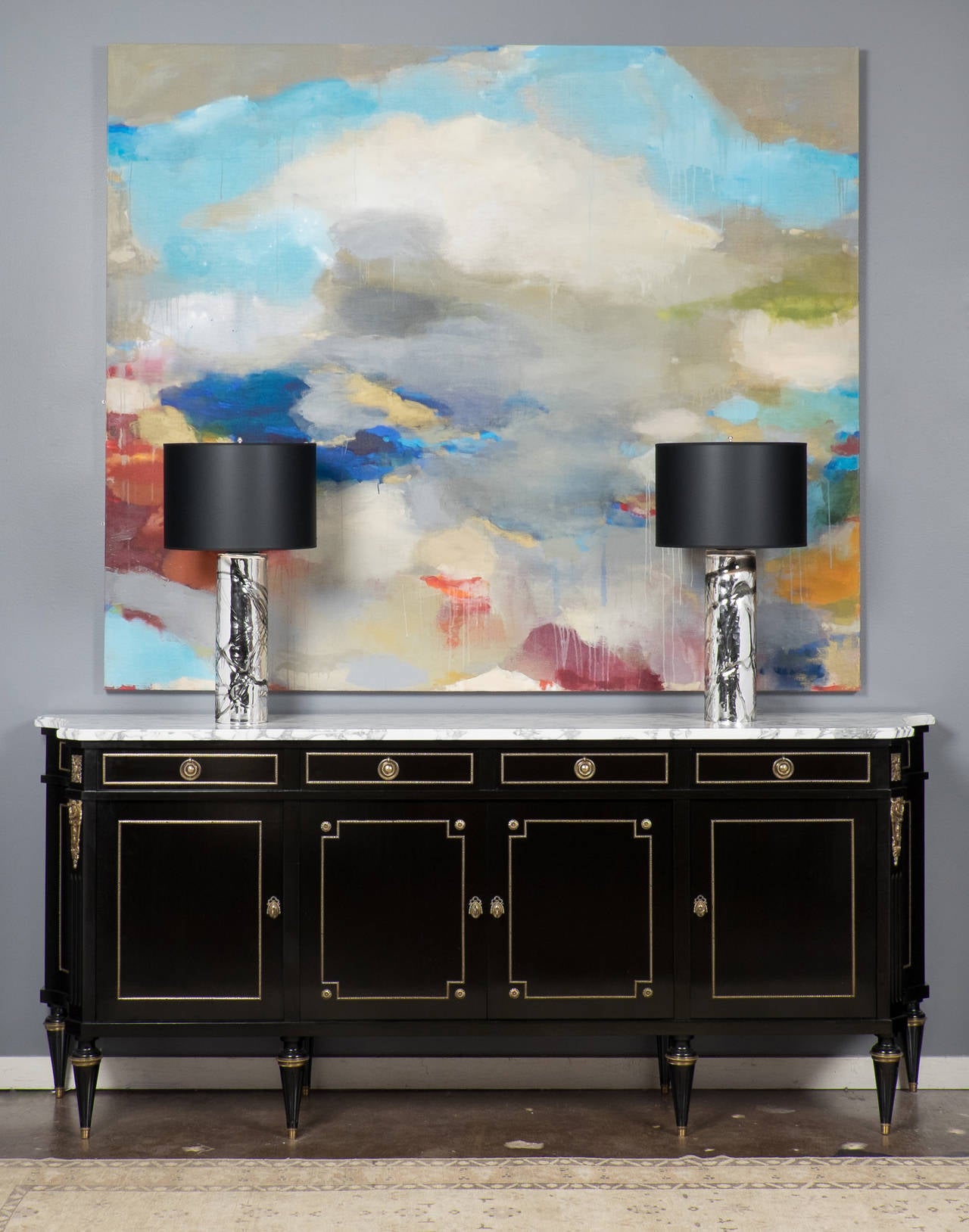 Striking pair of cylindrical Murano mercury glass table lamps, overlaid with smoked glass striations, topped with smoked glass discs, rewired for the US. The height of the glass is 18.5 in. These are the perfect decorative statement piece.

This