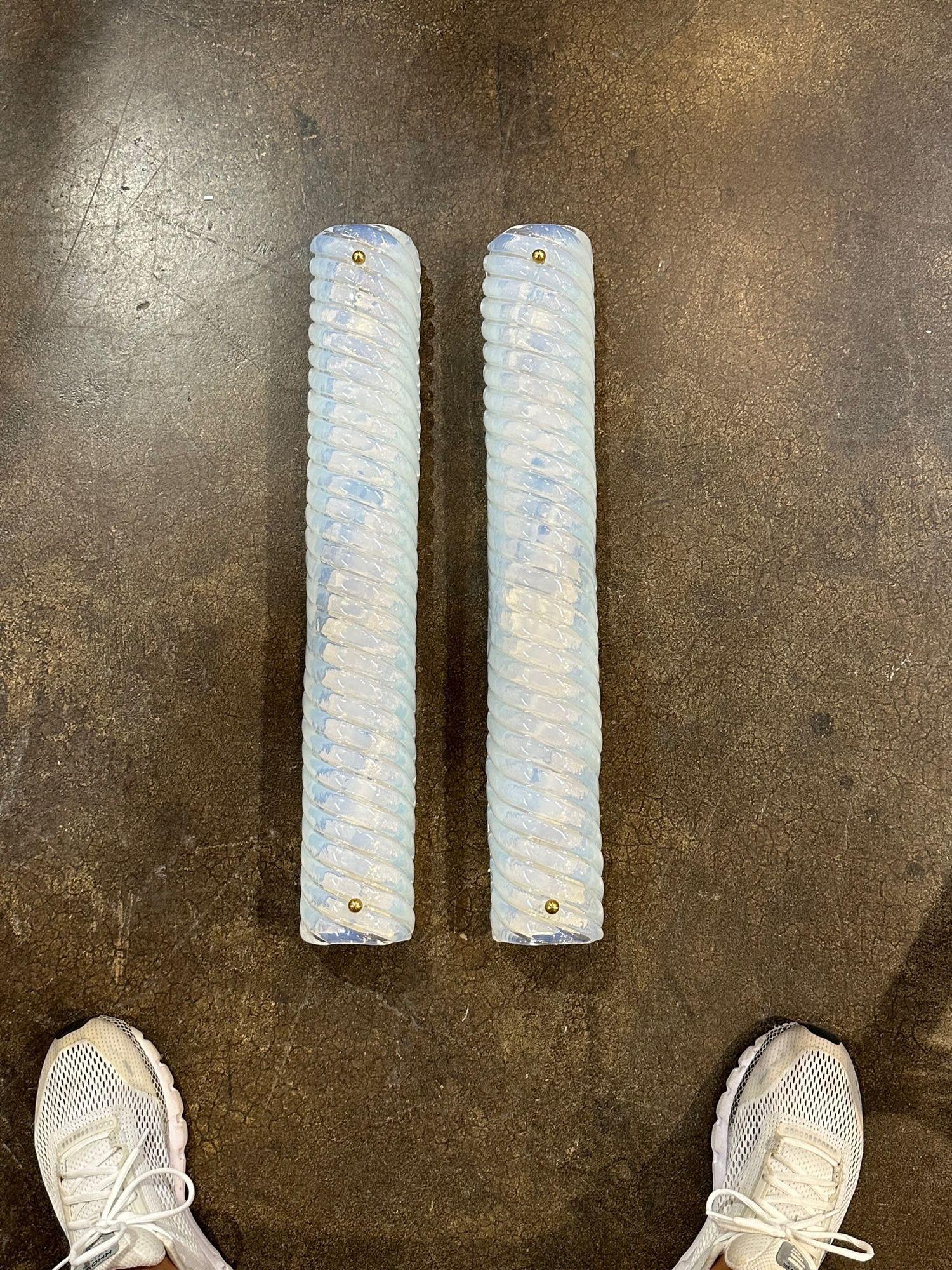 Pair of modern Murano opaline glass swirl tube form sconces. Circa 2000. The sconces have been professionally rewired and ready to hang. A timeless and classic touch for a fine interior.