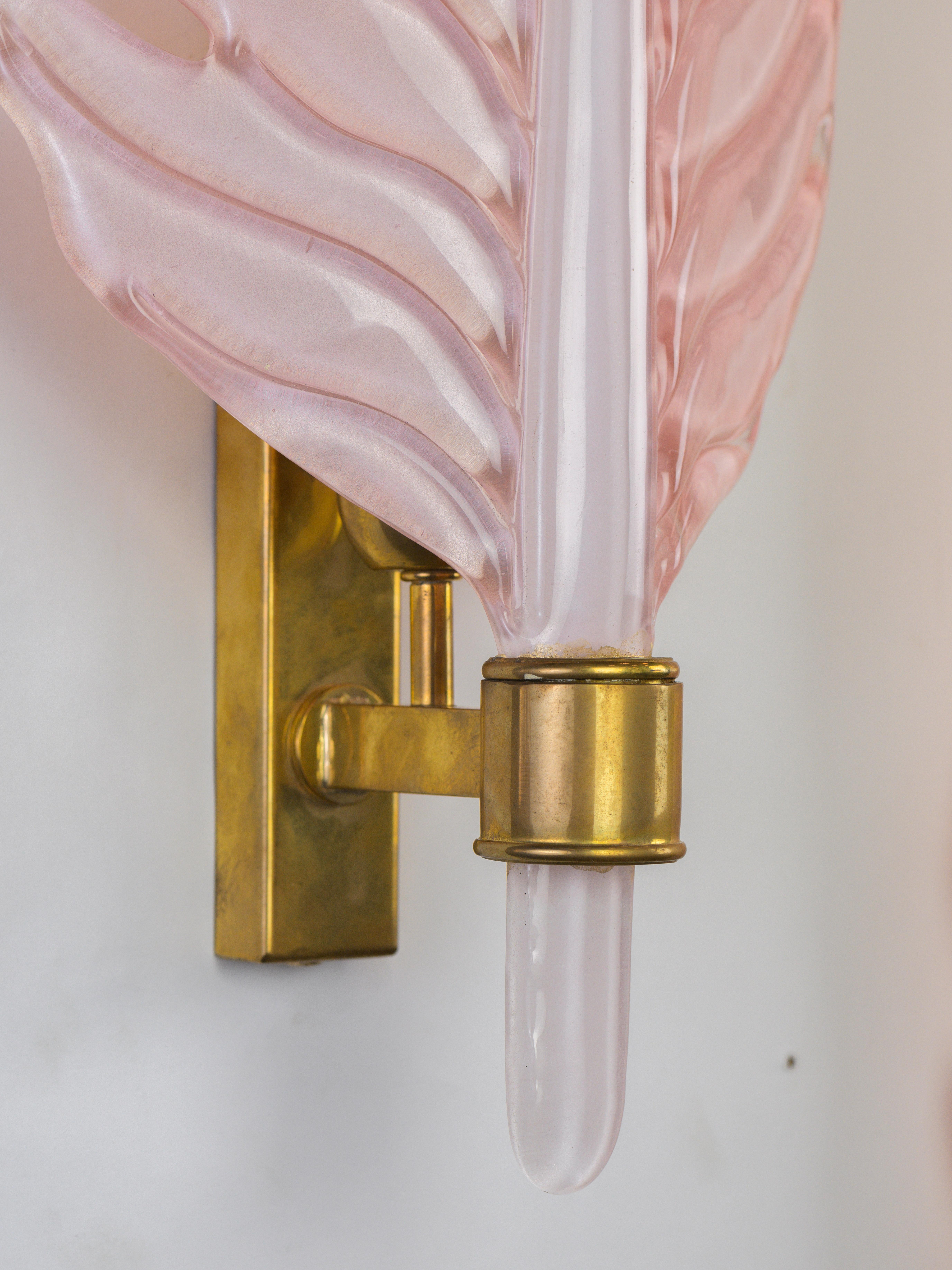 Lovely pair of wall lamps. The pink Murano glass will sublimate the light of the space. 
The brass structure is stong and easy to install. The glass is in perfect condition, the brass structure has a good patina. 
Don't hesitate to ask if you need