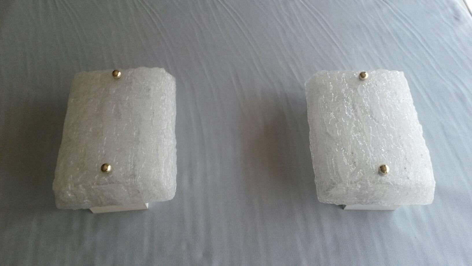 Beautiful Mid-Century Modern pair of sconces in Murano glass in a shape of an icy brick from late 1950s and beginning of the 1960s edited by Kalmar, Austria.

In an excellent general state without any traces. The electric part if it’s the US