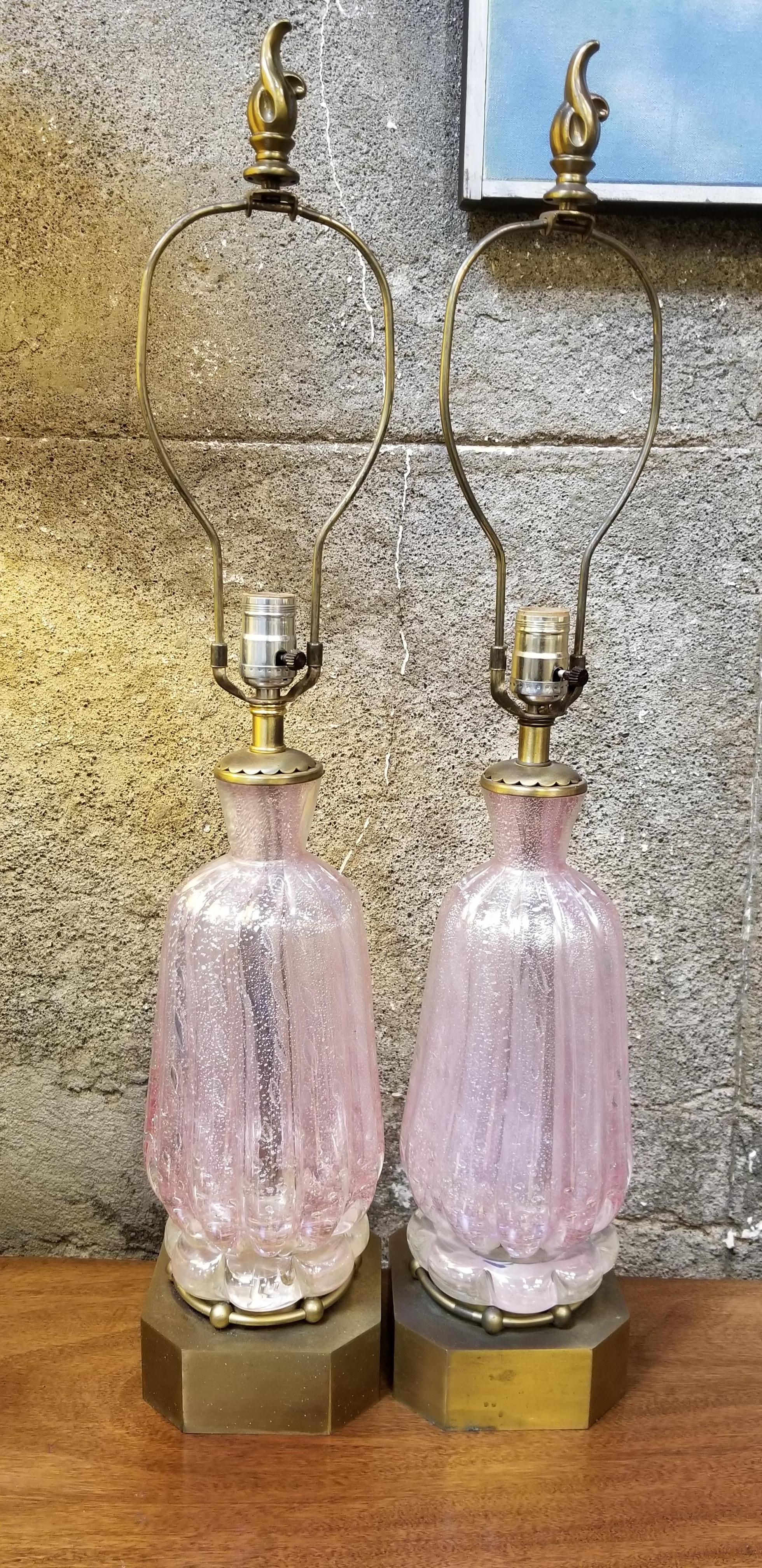 A pair of hand blown Murano glass table lamps, pink bubble glass with floating silver leaf detail. Original, vintage condition. Original brass bases. Original harps and flame brass finials, circa 1960s. No shades. Glass only measures 13.25 inches in