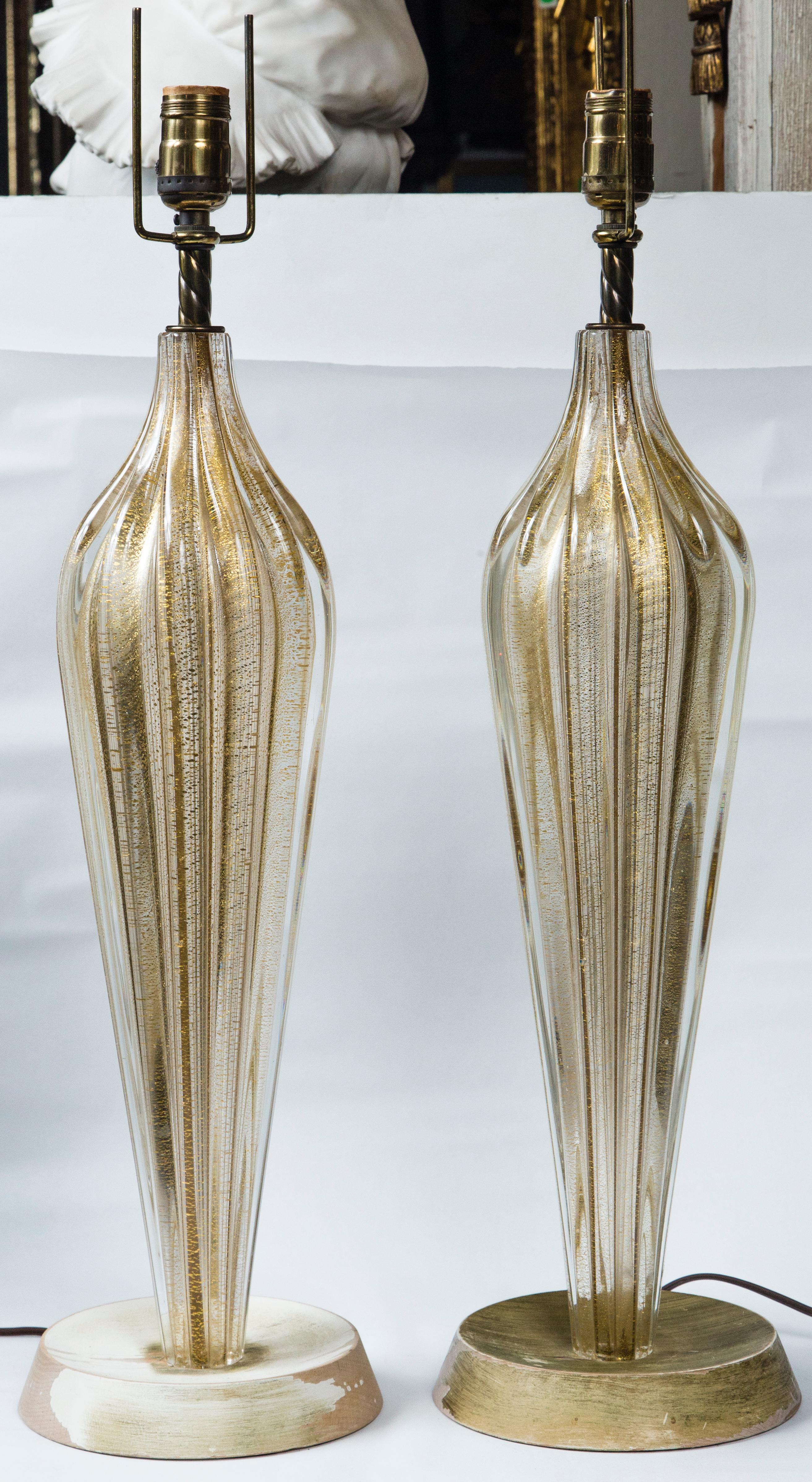 Of gold and clear thick glass in long inverted teardrop shape, ribbed. The gold appears to be gold colored 