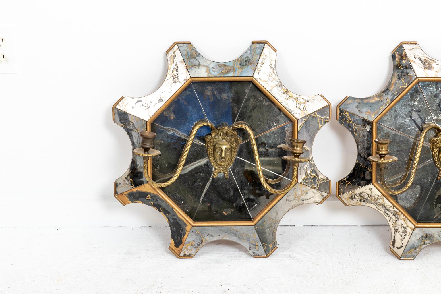 Pair of Murano two arm sconces with figural motif on the sunburst shaped mirror back. Please note of wear consistent with age including patina and oxidation to the mirror back.
