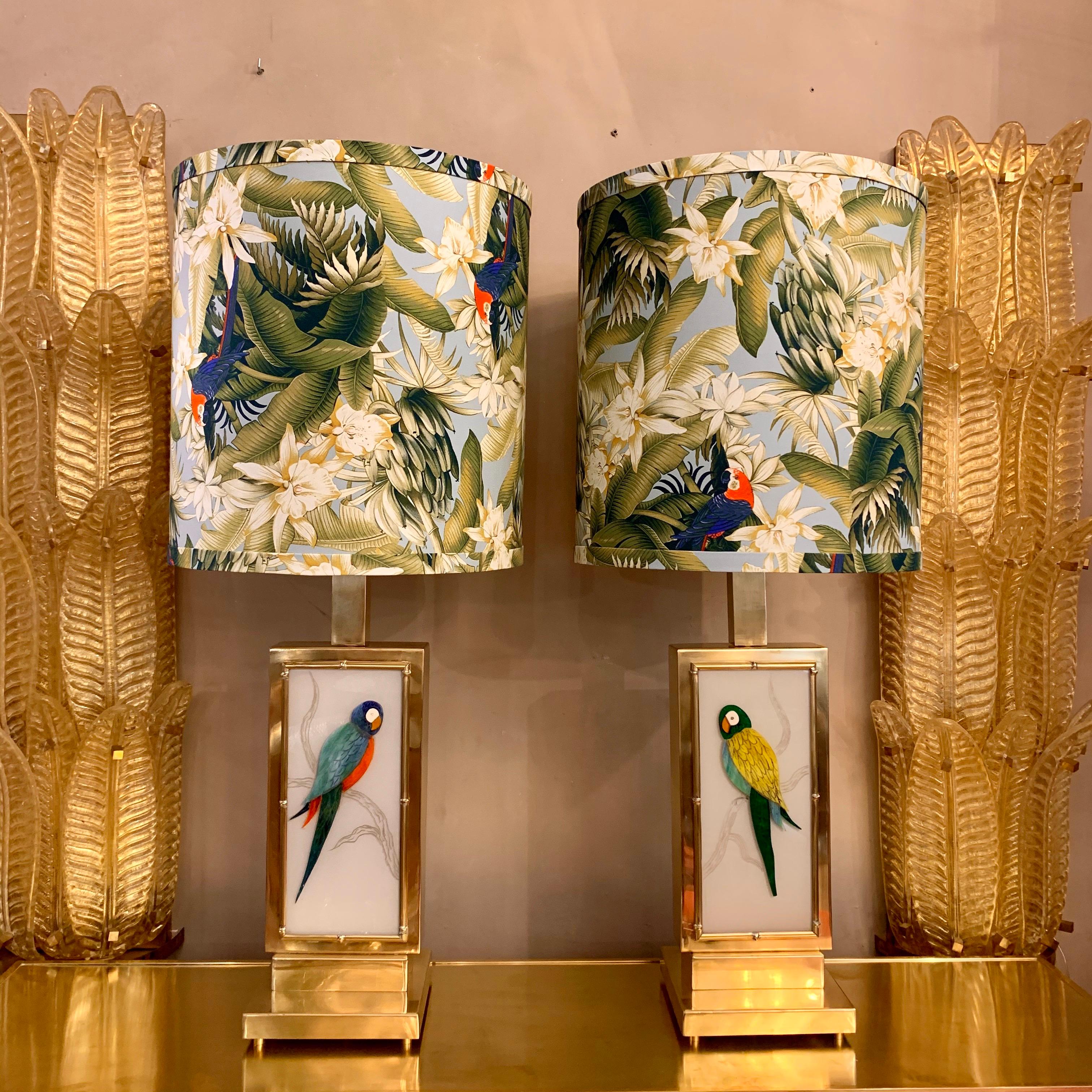 Pair of Murano two-sided glass parrots table lamps, brass structure with bamboo effect.
Each lamp has two-sided glass parrots cut by hand with different Murano glass colors.
We have realized handcrafted lampshades with Pierre Frey cotton fabric.