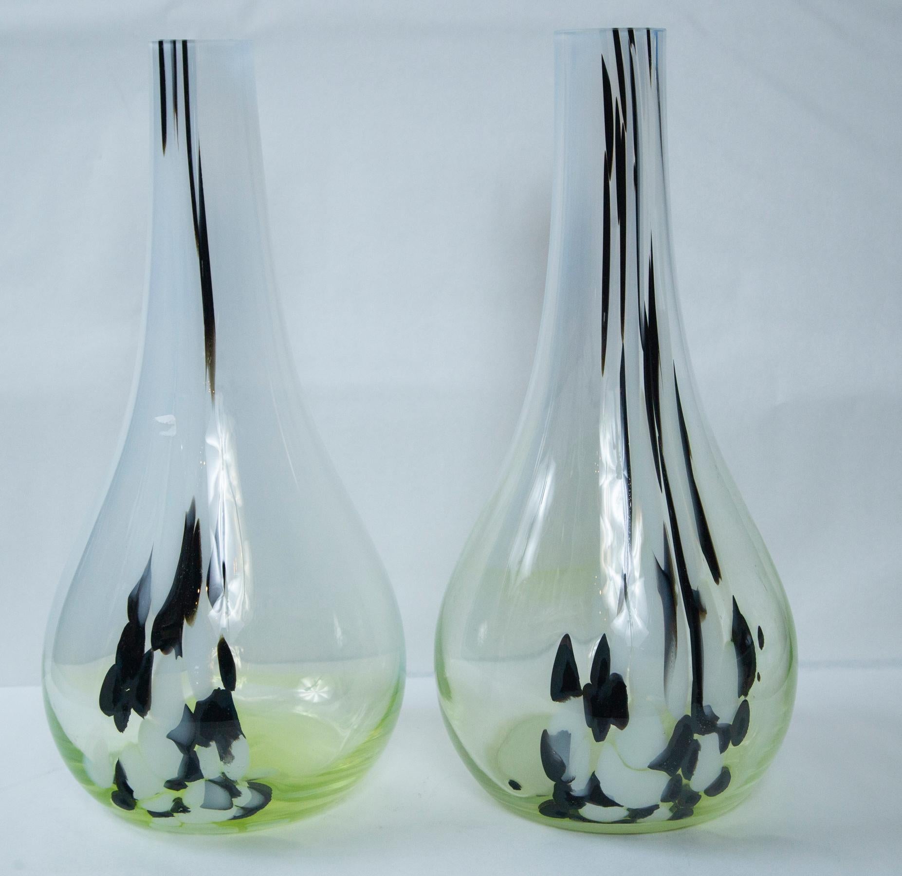The pair are unsigned but according to the previous owner, were bought in Venice in the 1960s.
Milky white glass with glass streaks of black and white and a yellow/green bottom.
   