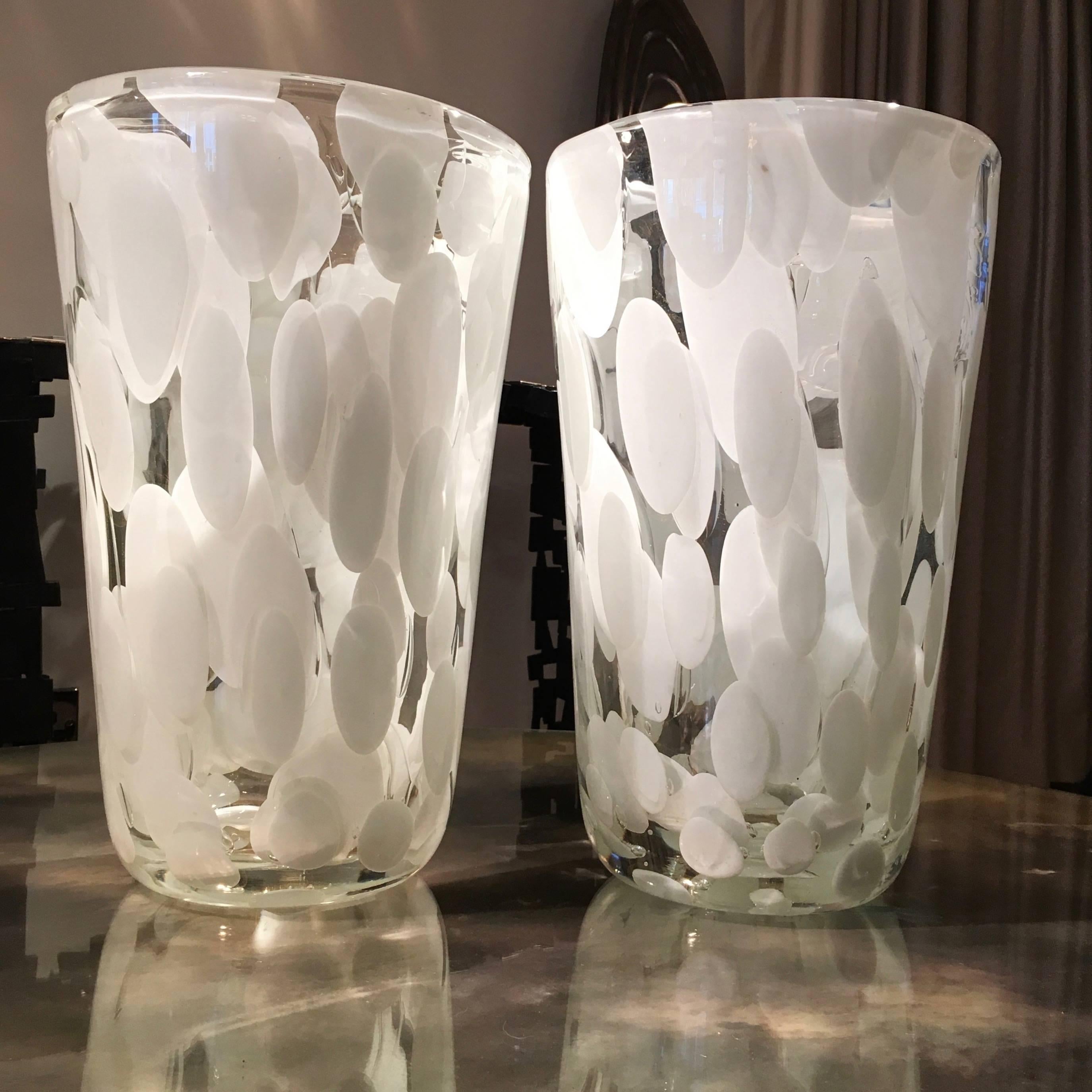 A pair of new Murano vases with white details and delicate flecks of gold leaf inside the glass. Produced on the Island of Murano, these vases are handblown allowing each to be unique.