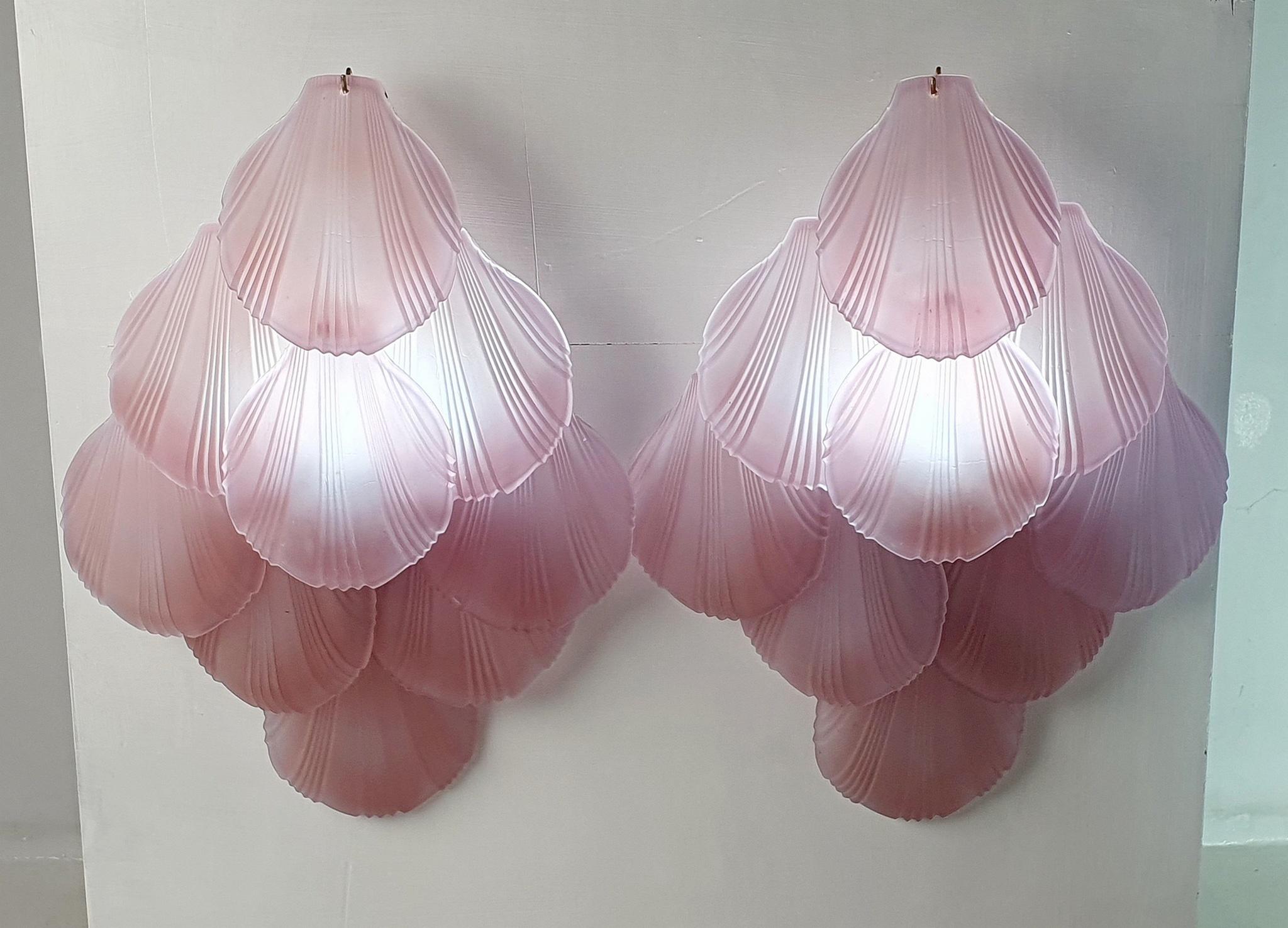 Pair of fabulous and extra large vintage wall sconces. Each sconce has nine pieces of clam shaped glass discs mounted on to a brass structure in matte glass. And the color will look pale purple when unlit and more towards pink when lit. Excellent
