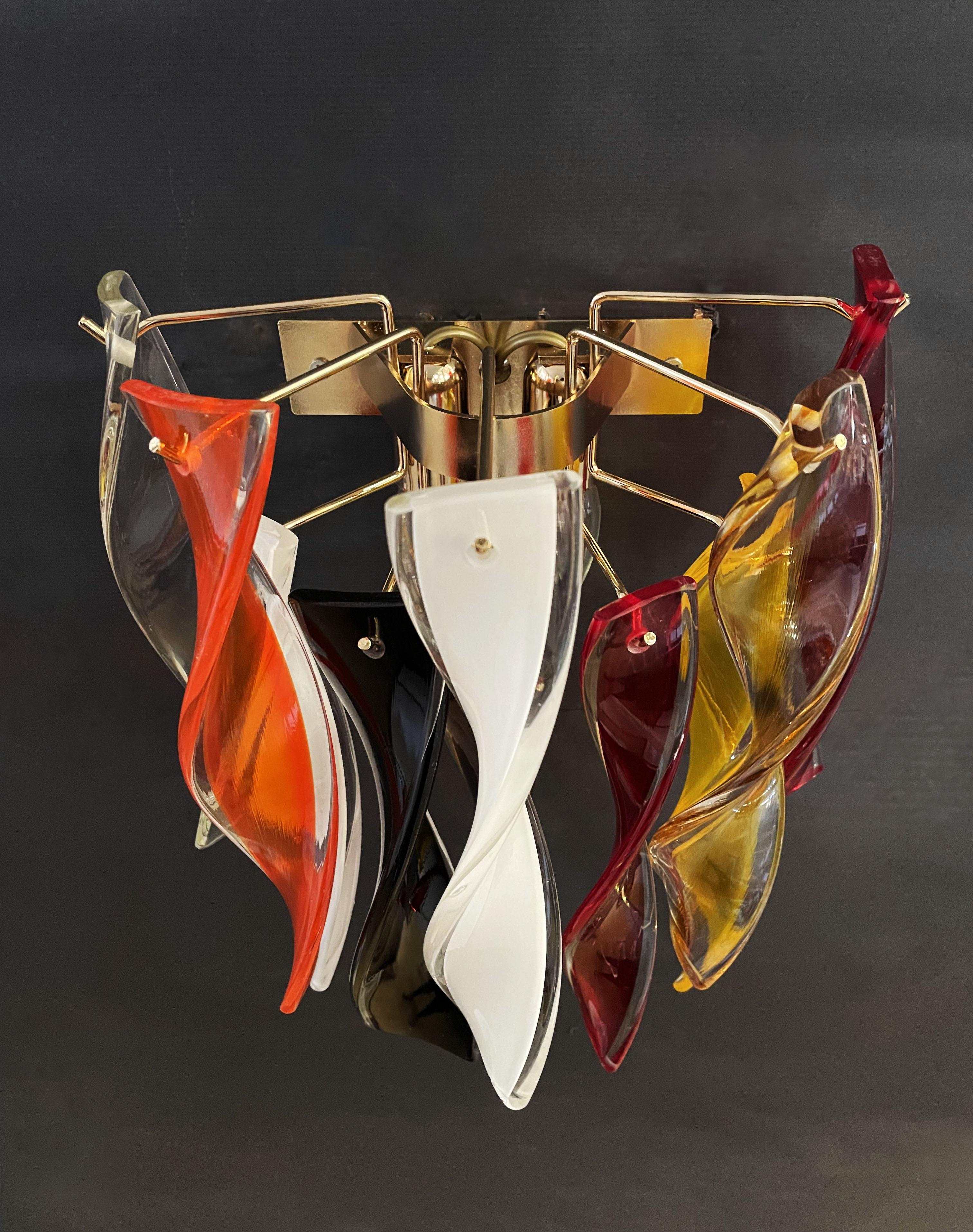 Pair of appliques with 10 pendants in colored Murano glass covered with crystal and hand-twisted in various colors. Gold-plated structure.
Period: late XX century
Dimensions: 15,75 inches (40 cm) height; 11,80 inches (30 cm) width; 7,10 inches (18