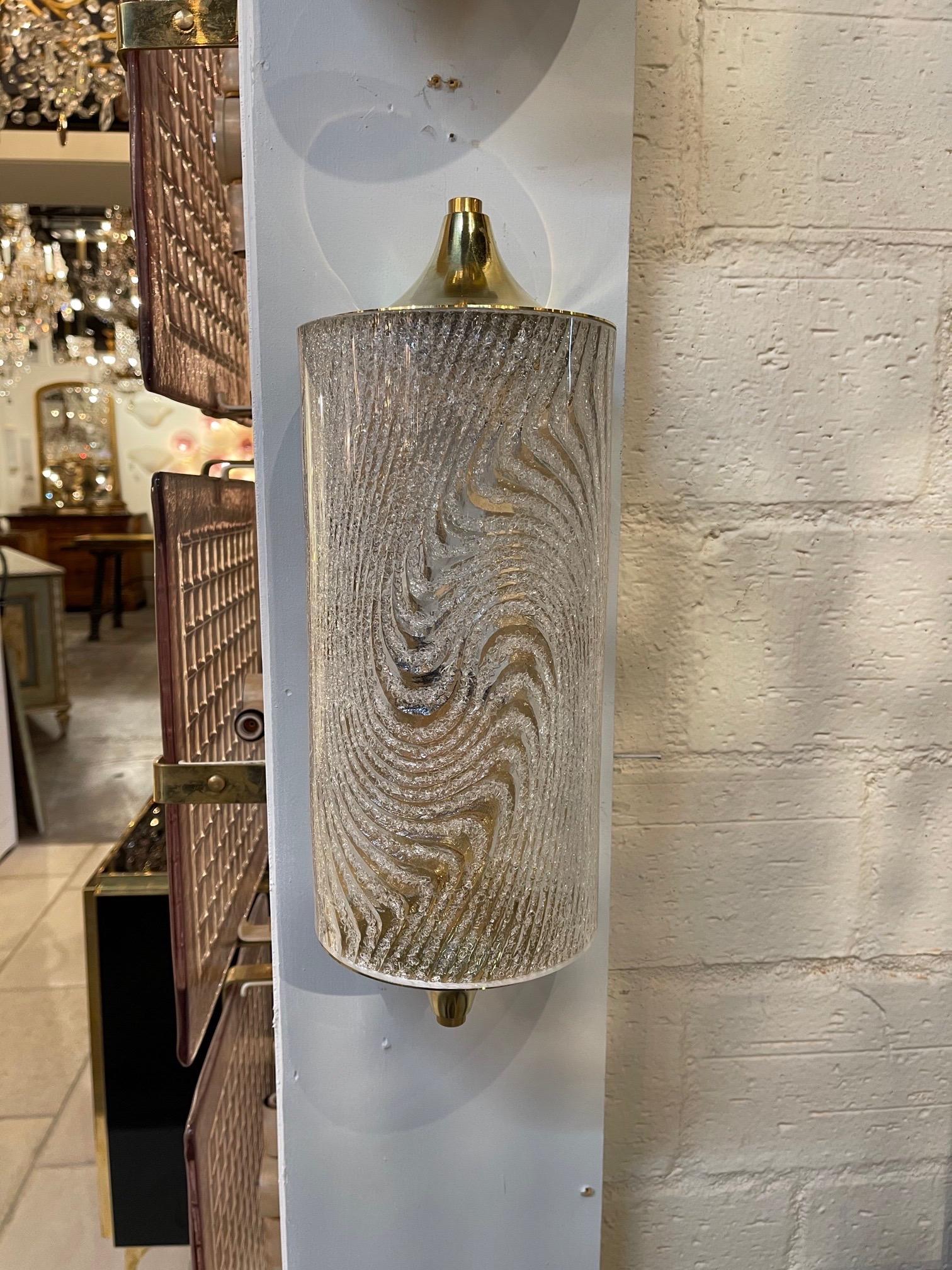 Great pair of Murano glass and brass barrel form sconces.  Beautiful wave pattern on the glass.  A fabulous decorative element!!
