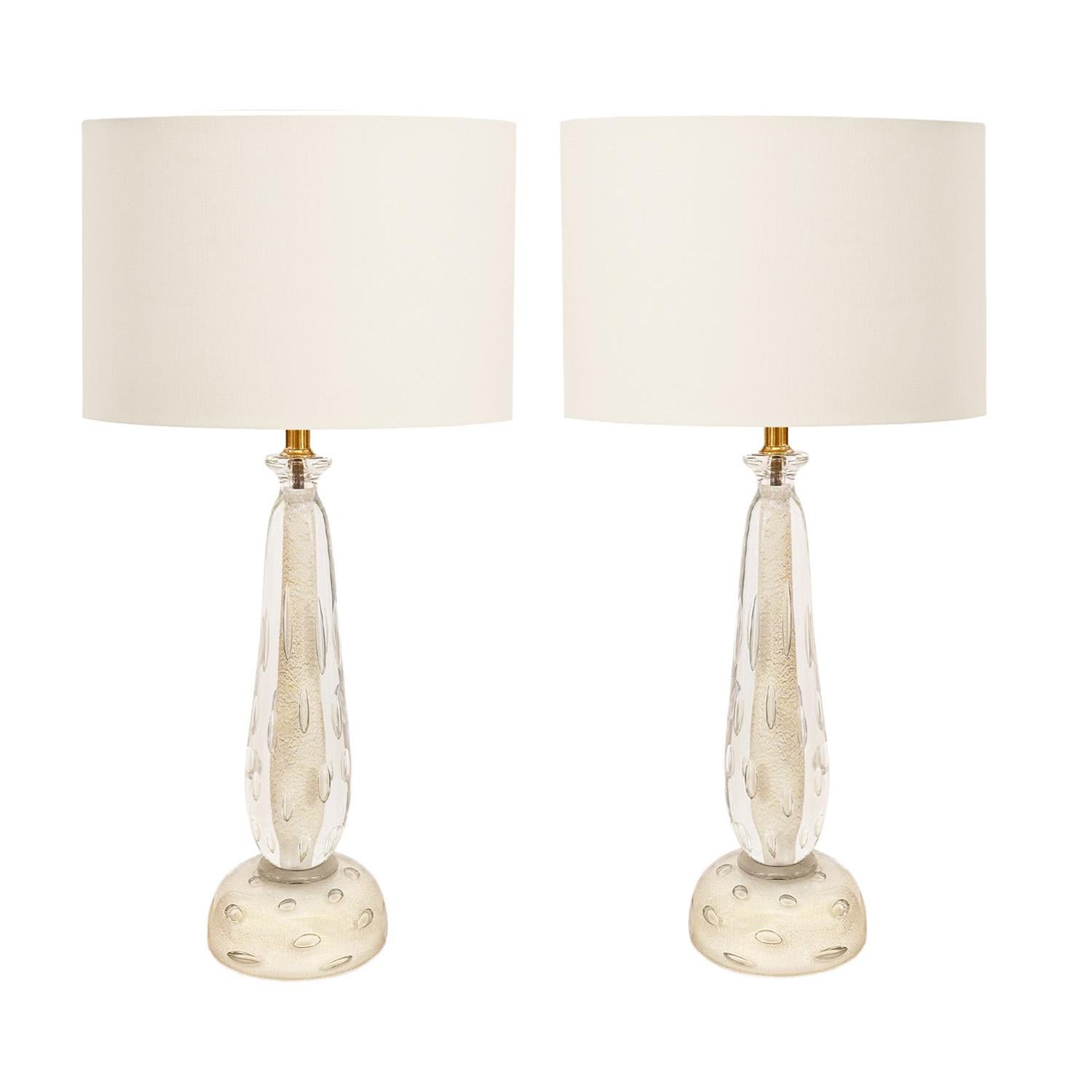 Exceptional pair of 1950's Murano sommerso white and clear glass table lamps containing exaggerated bullicante with avventurina and hardware finished in golden brass. Although not attributed to a particular glass house or artist, this beautifully