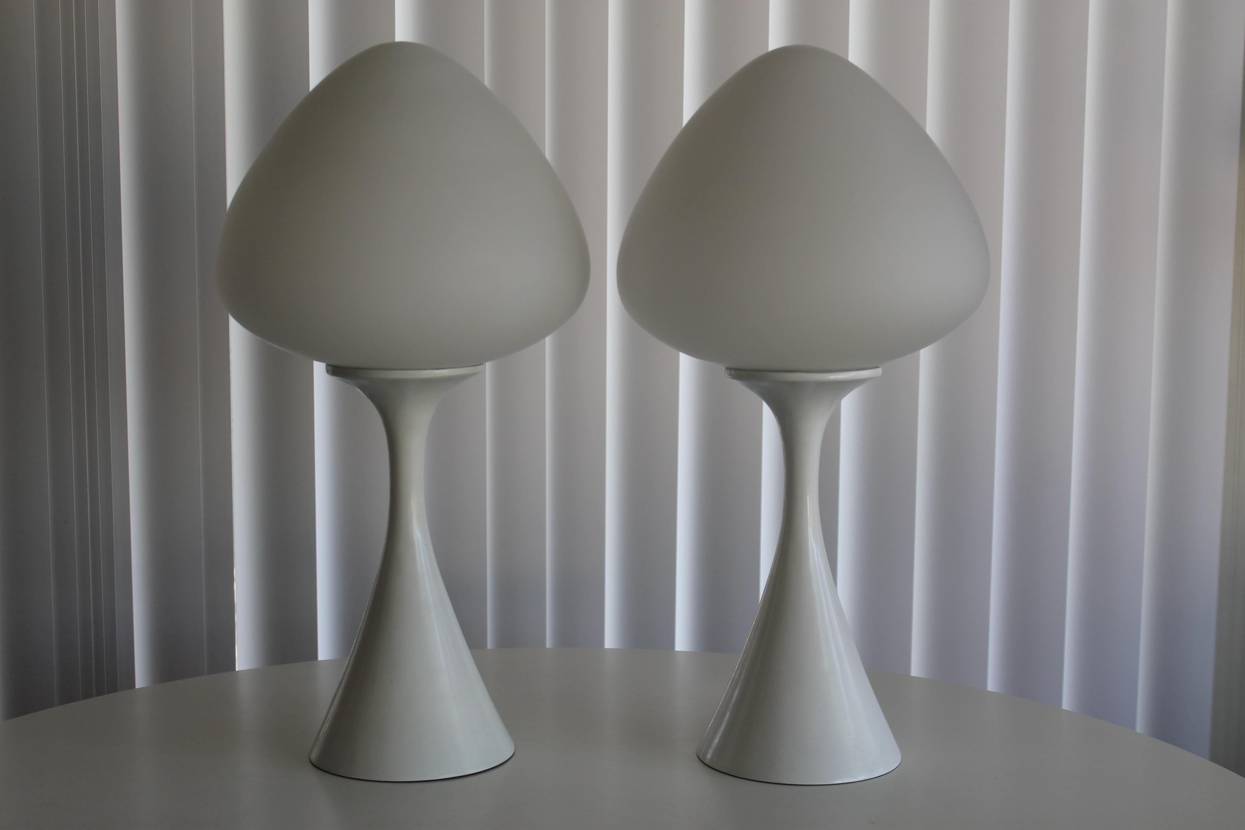 A matched pair of mushroom lamps by the Laurel Lamp Company. They have their original white finish, with acorn style globes. Lamps are all original. Lamps measure 19