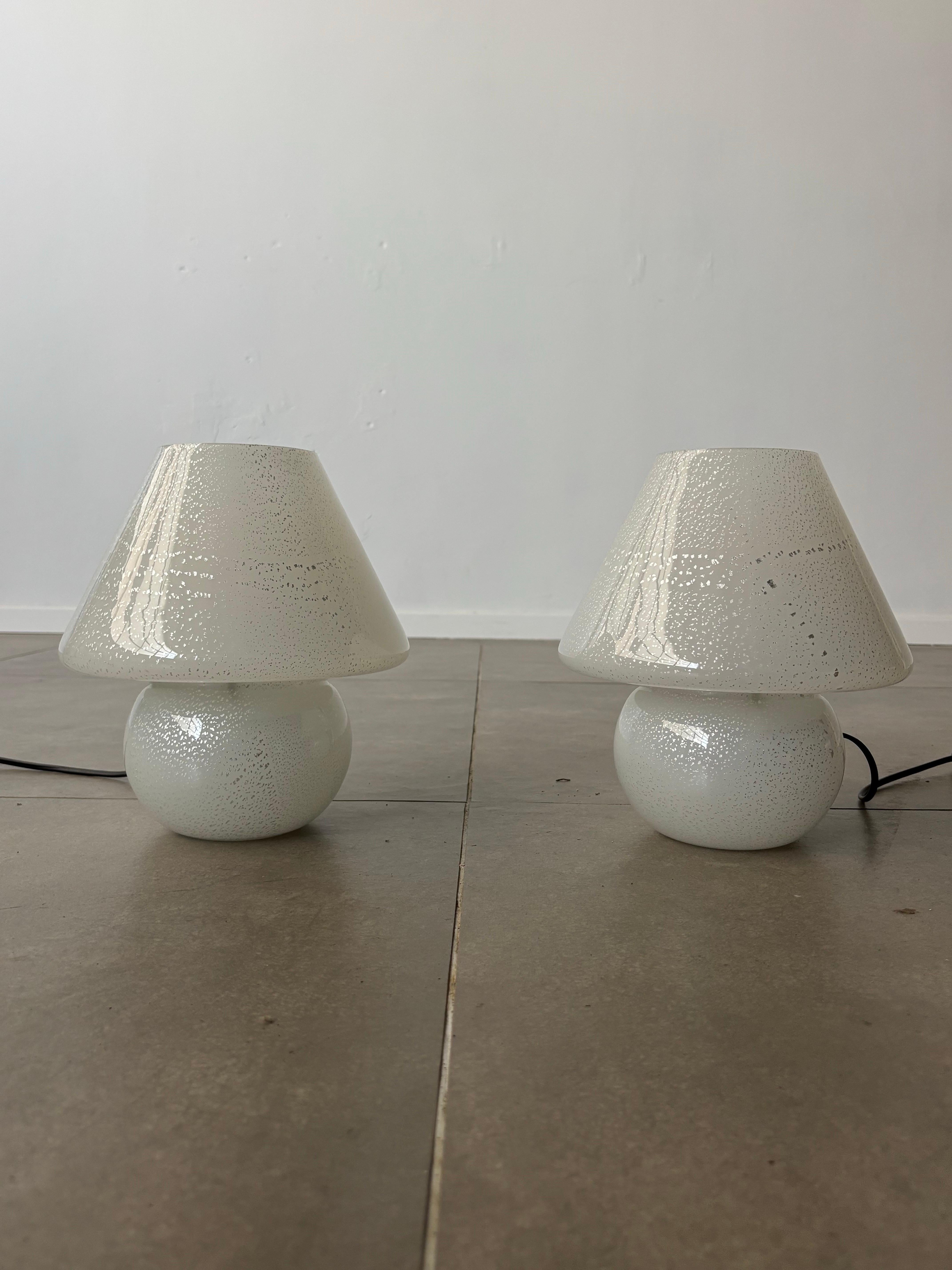 This elegant pair of Mushroom table lamps, crafted in Italy during the 1960s, embodies the timeless sophistication of Murano glass. Their fluid, organic shape, reminiscent of a delicate mushroom, is achieved through the meticulous art of hand-blown