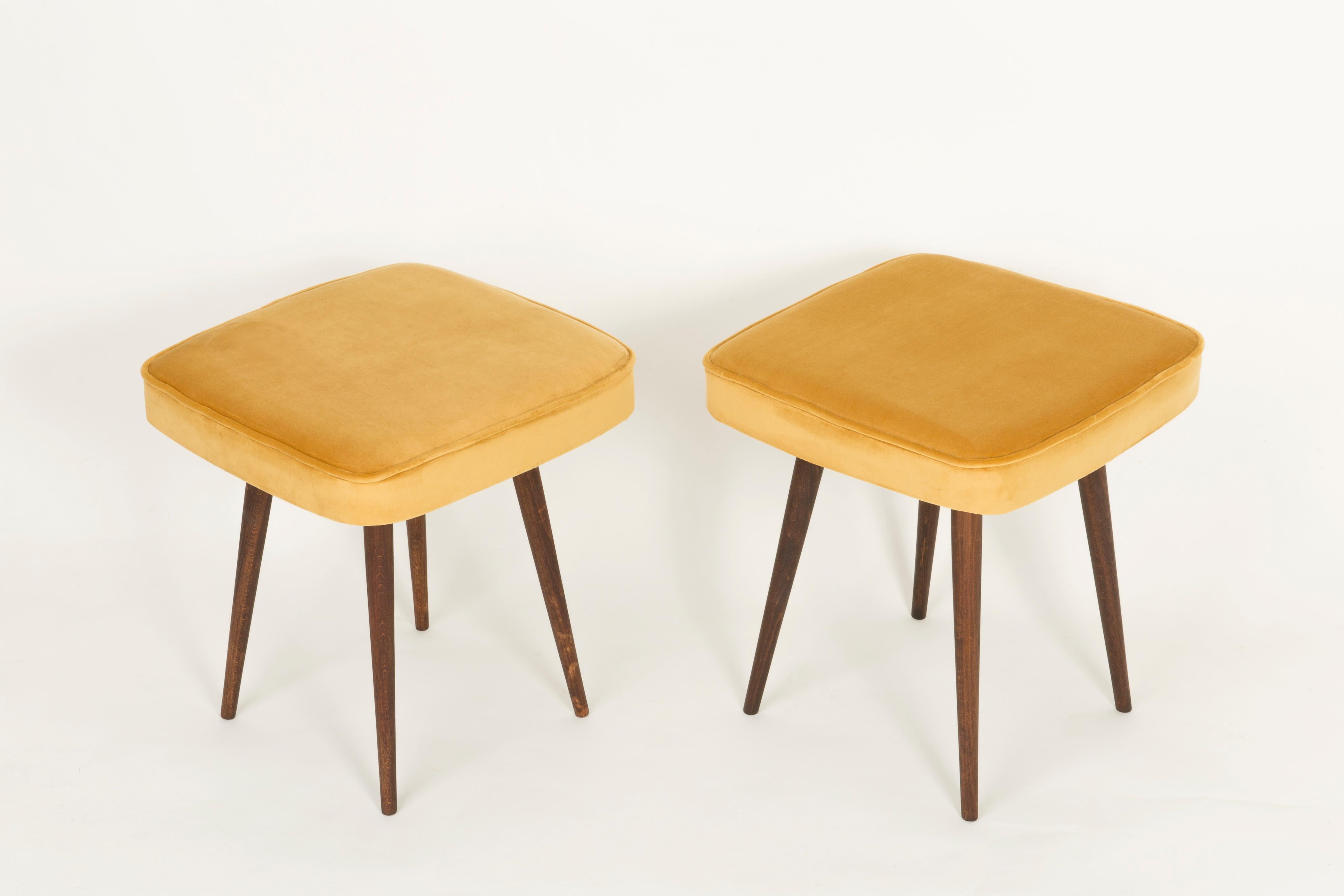 Stools from the turn of the 1960s and 1970s. Beautiful mustard velor upholstery. The stools consists of an upholstered part, a seat and wooden legs narrowing downwards, characteristic of the 1960s style. We can prepare this pair also in another