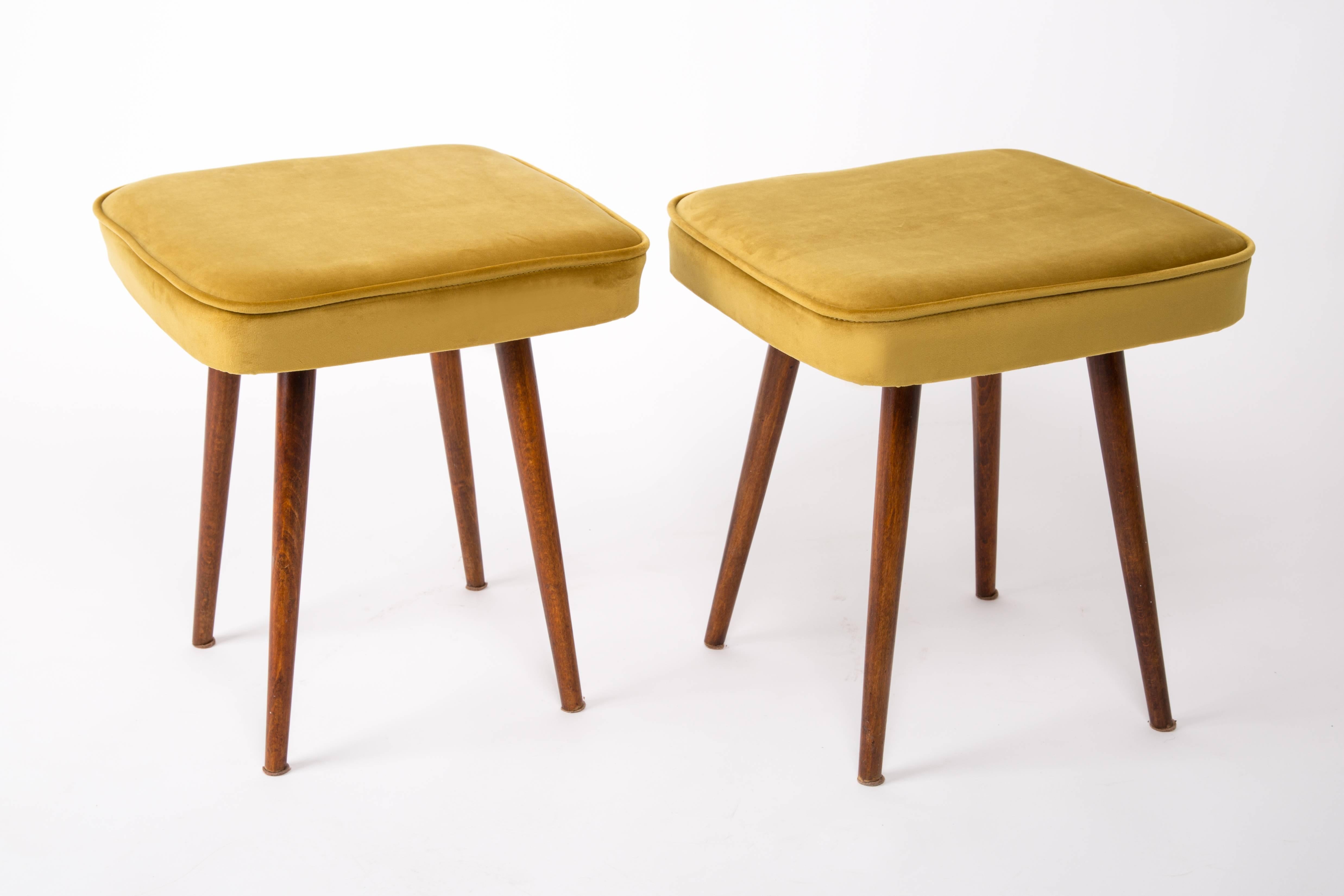 Stool from the turn of the 1960s and 1970s. Beautiful mustard velor upholstery. The stool consists of an upholstered part, a seat and wooden legs narrowing downwards, characteristic of the 1960s style. We can prepare this pair also in another color
