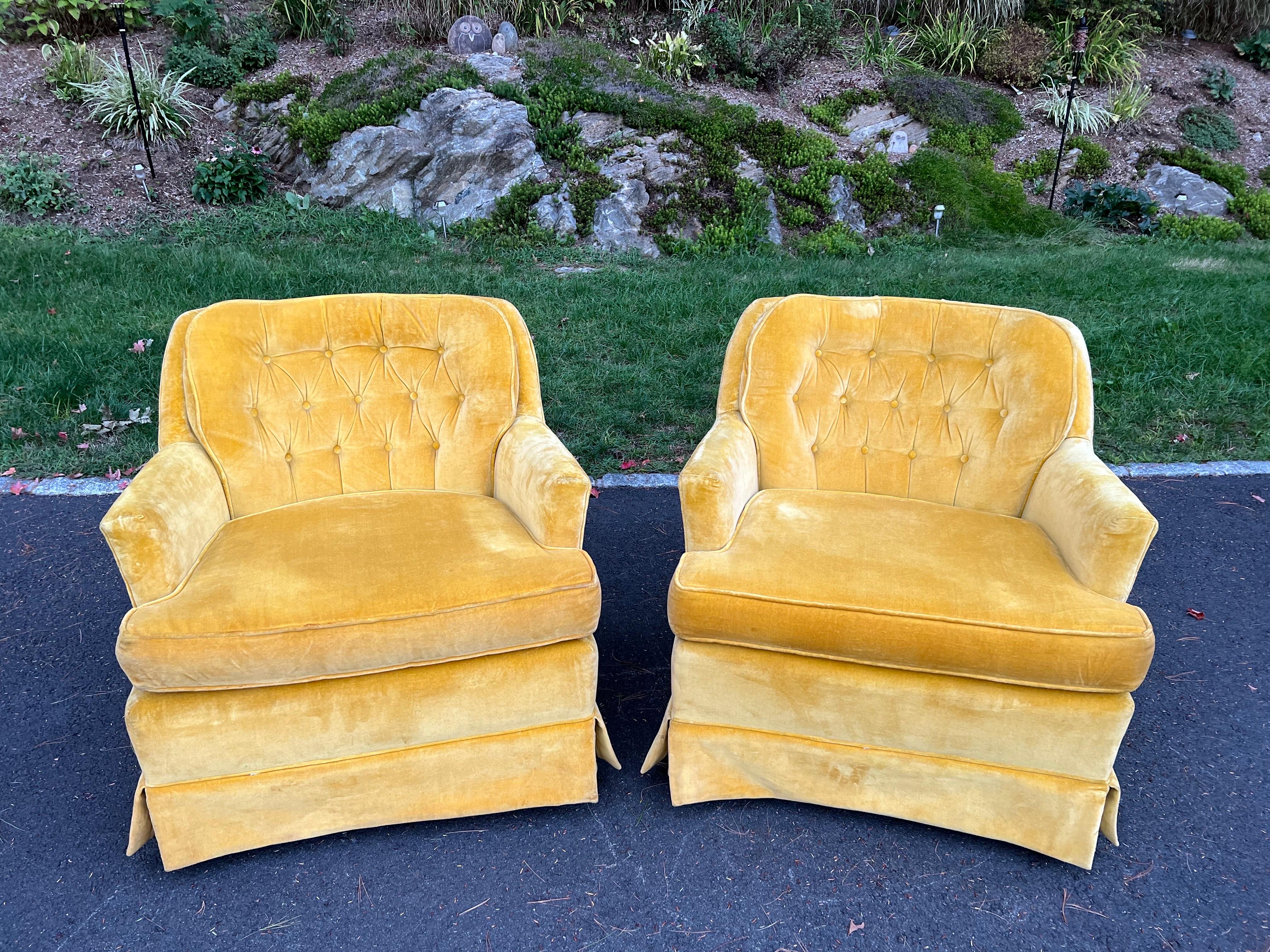 Pair of Mustard Yellow velvet club chairs. Made by Arcadian Furniture out of Conover, North Carolina . Which has been in business since 1966. Classic shape and style with a skirted /pleated base on four wooden legs.
   
