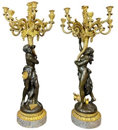 Pareja de candelabros mitológicos figurados de bronce patinado y ormolina de nueve luces