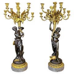 Pareja de candelabros mitológicos figurados de bronce patinado y ormolina de nueve luces