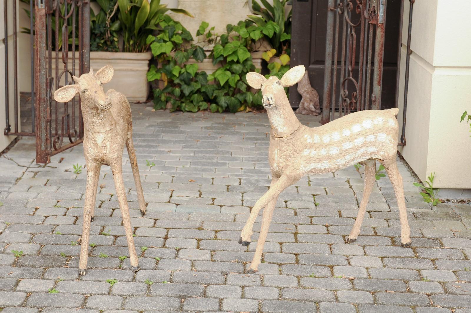 A pair of American carved wooden fawns from the first half of the 20th century. Found in a lodge in New Hampshire, each of this pair of fawns boasts a charming naive appearance. Carved and painted, the fawns capture our hearts with their tender