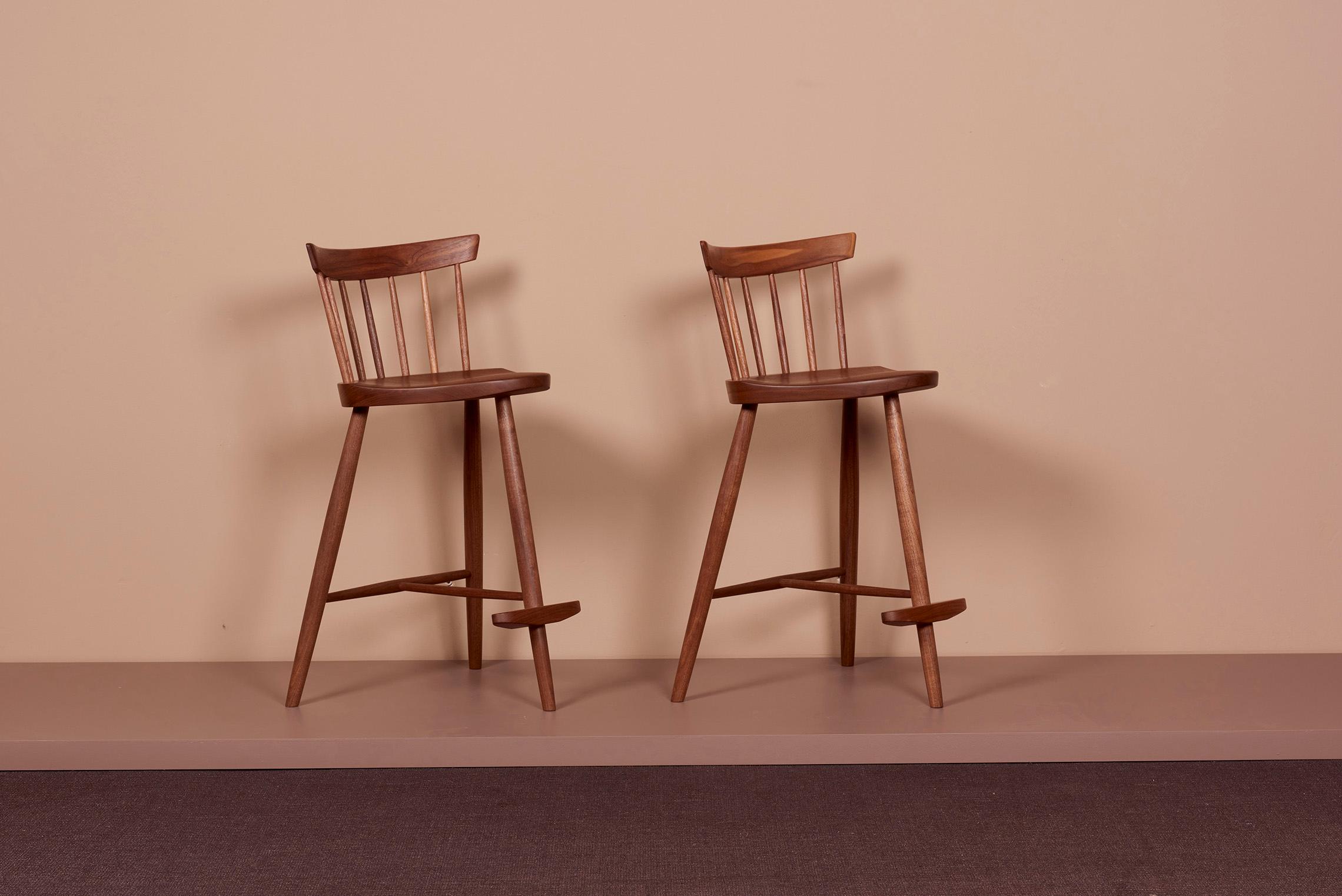 Pair of Nakashima Studio Mira Nakashima Mira bar stools in walnut, US 2021
The chairs are in black walnut and signed.
 