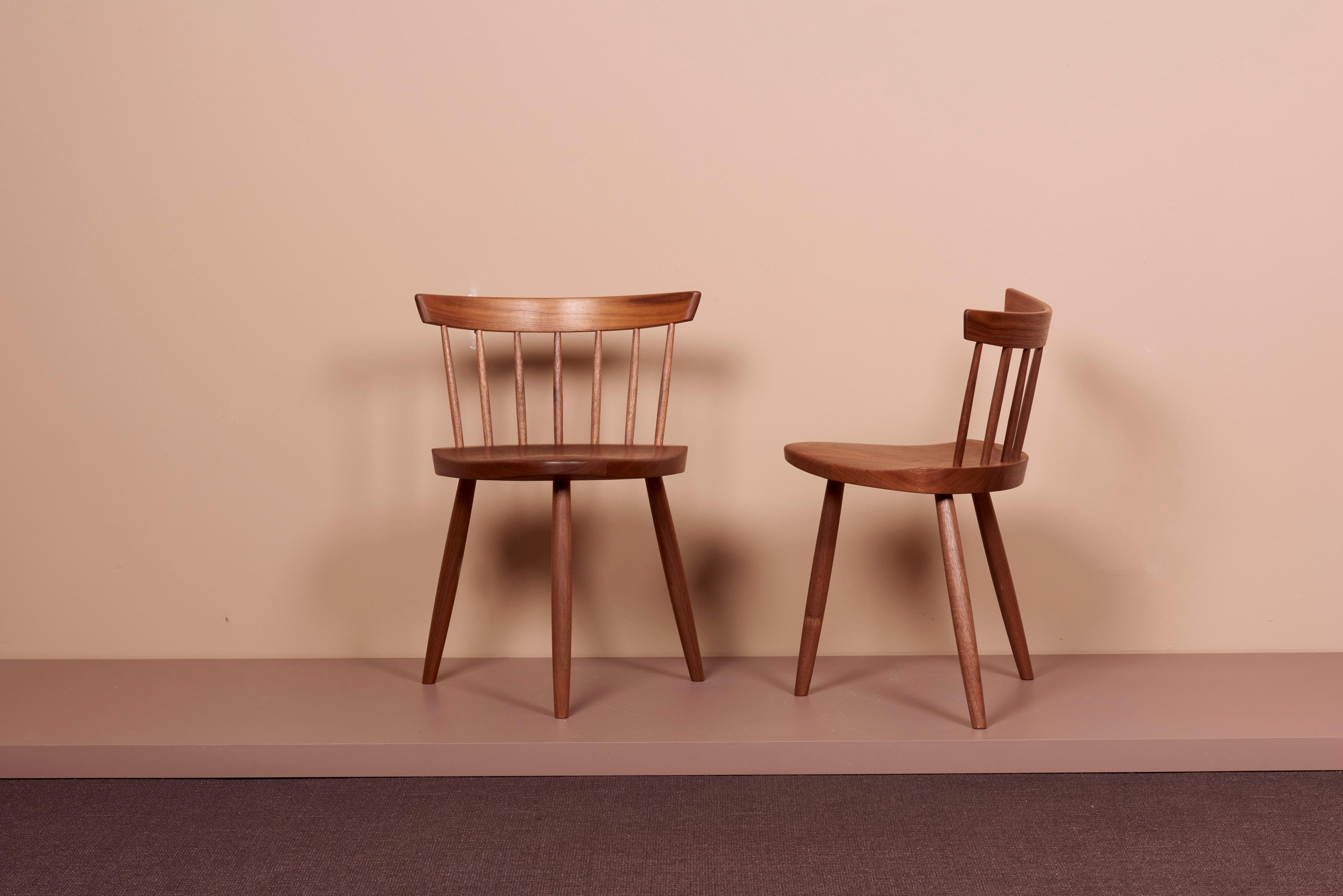 Pair of Mira Chairs by Mira Nakashima based on a design by George Nakashima. The chairs are in black walnut and can be signed. Production lead time is around 18 months. Please get in touch with us for further information. 
  
