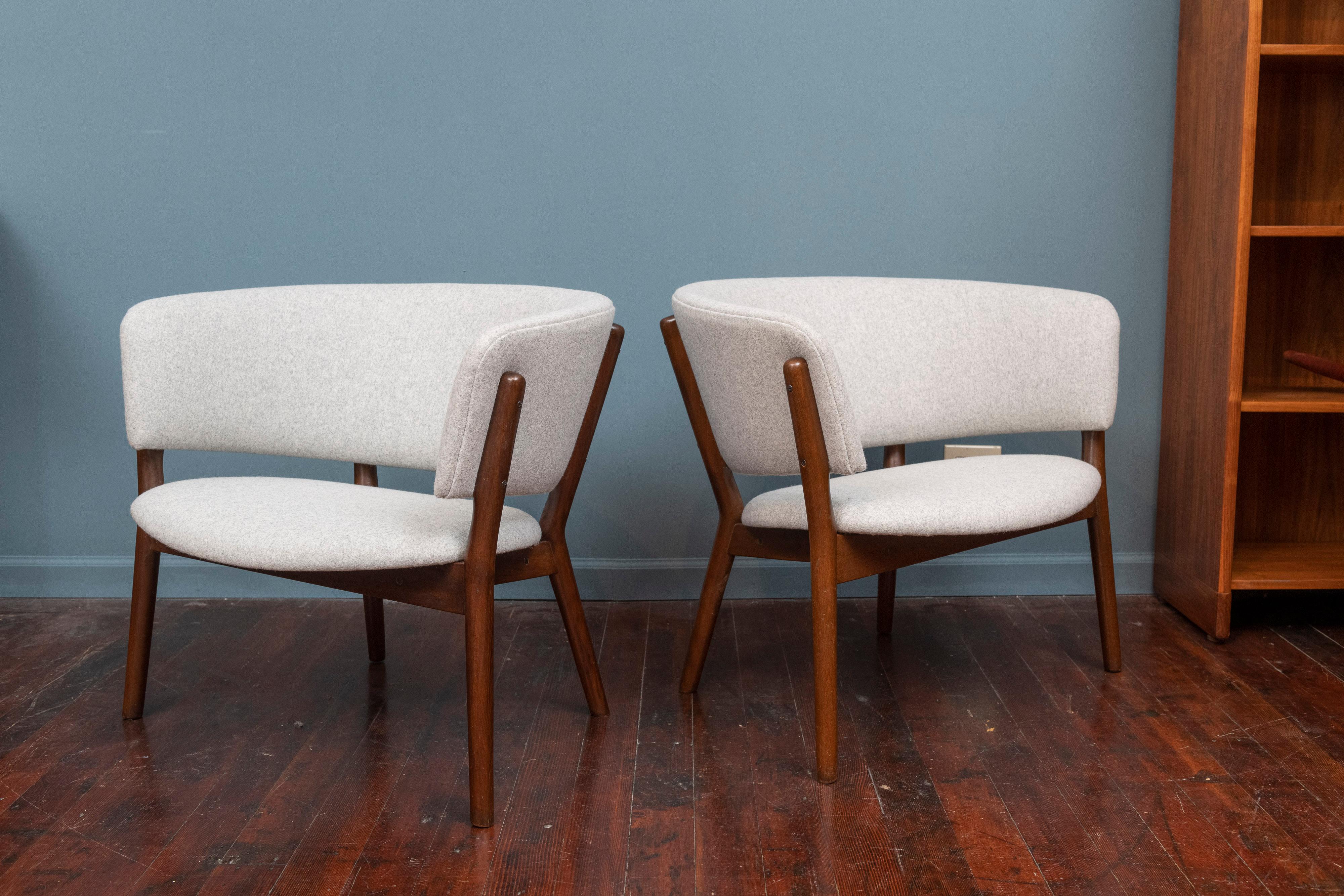 Pair of Nanna Ditzel design lounge chairs, newly upholstered in a light grey wool with refinished frames.