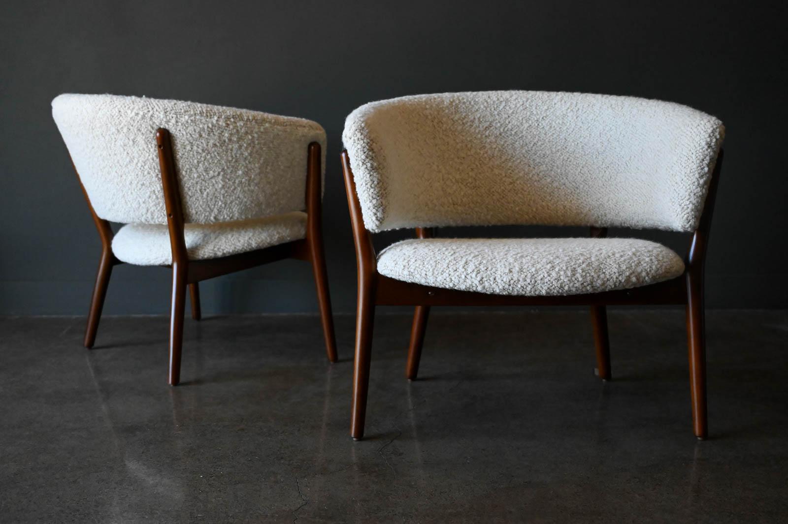 Pair of Nanna Ditzel Model 83 Lounge chairs in Pierre Frey Wool Bouclé, 1952. Original pair, professionally restored walnut finish with top of the line soft Pierre Frey Wool Boucle. Beautifully designed and very comfortable, these chairs are highly