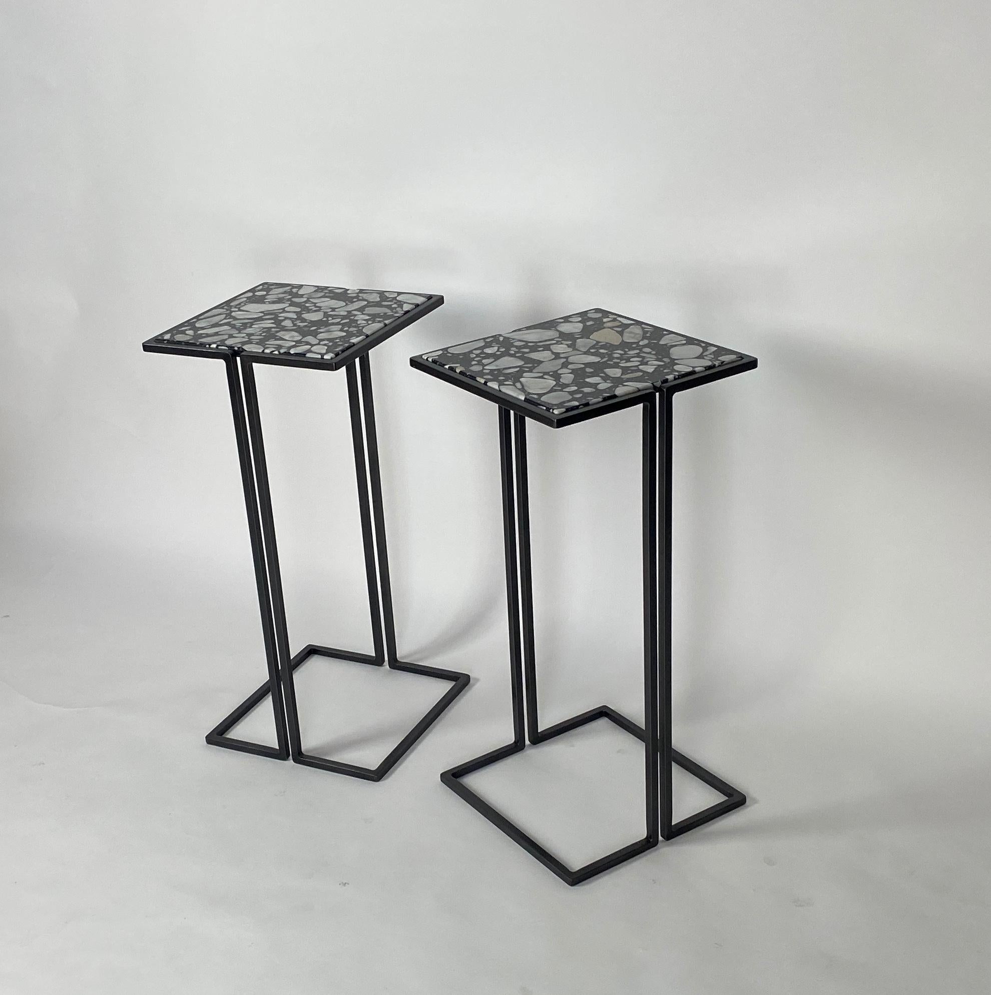 Two small-scale side tables.
Minimalist design with gun metal patina frames and Palladrio Moro marble tops.
Versatile tables, perfect for cocktails, laptops. These side tables nestle nicely around the arms of chairs to provide a nice sized