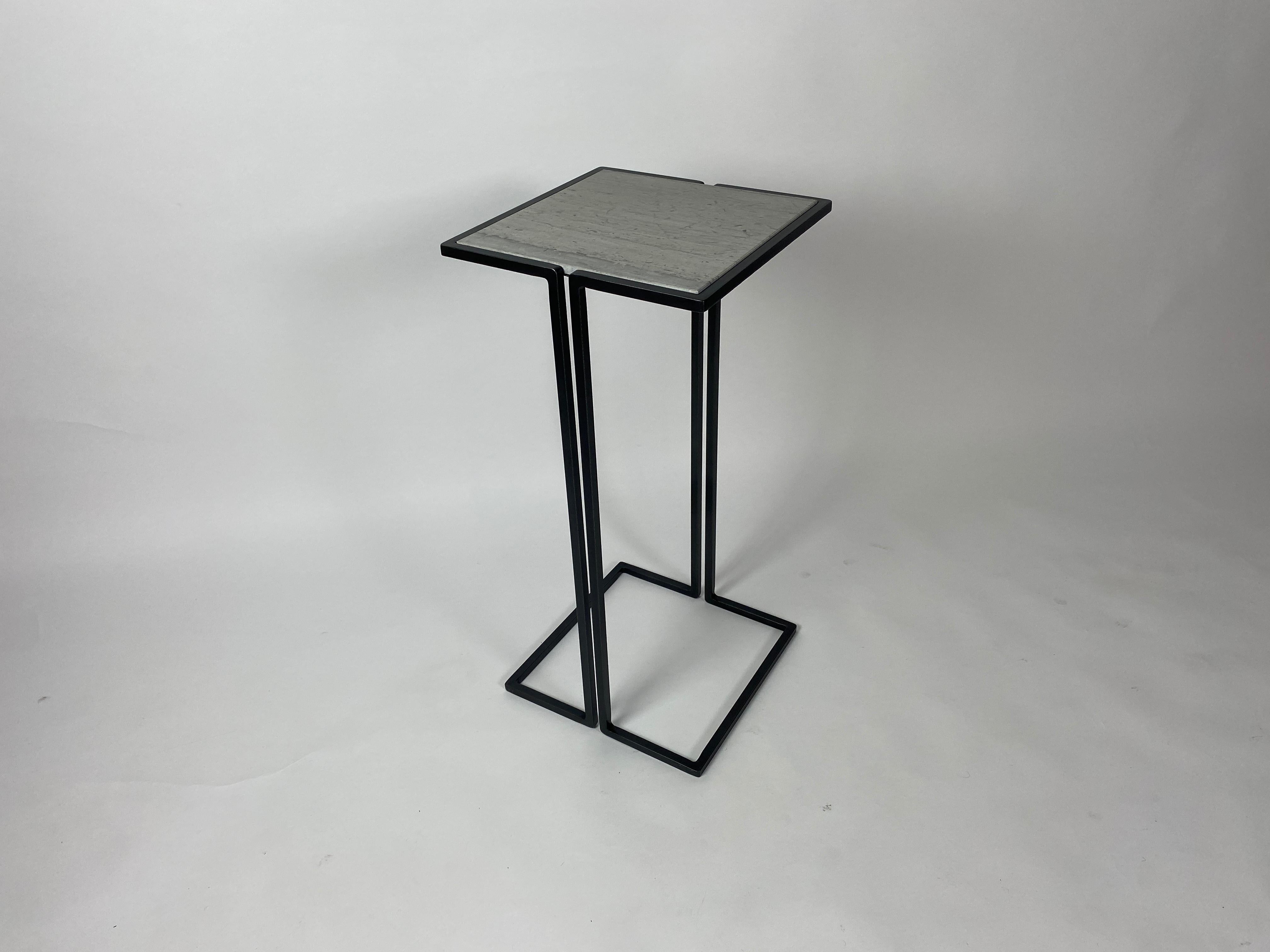Two small-scale side tables.
Minimalist design with gun metal patina frames and polished linac marble tops.
Versatile tables, perfect for cocktails, laptops. These side tables nestle nicely around the arms of chairs to provide a nice sized