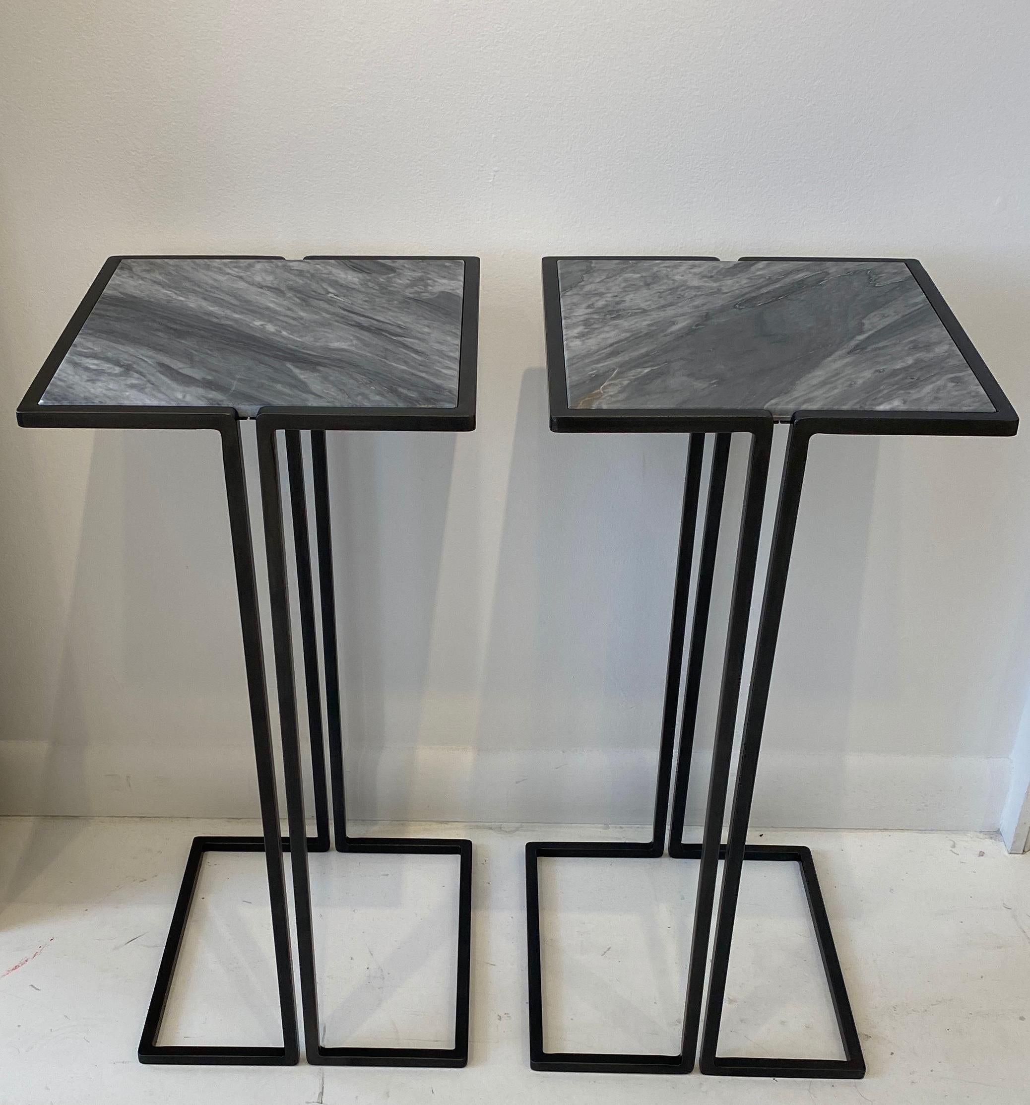 Two small-scale side tables. Minimalist design with gun metal patina frames and grey slate marble tops. Versatile tables, perfect for cocktails, laptops. These side tables nestle nicely around the arms of chairs to provide a nice sized multi-use