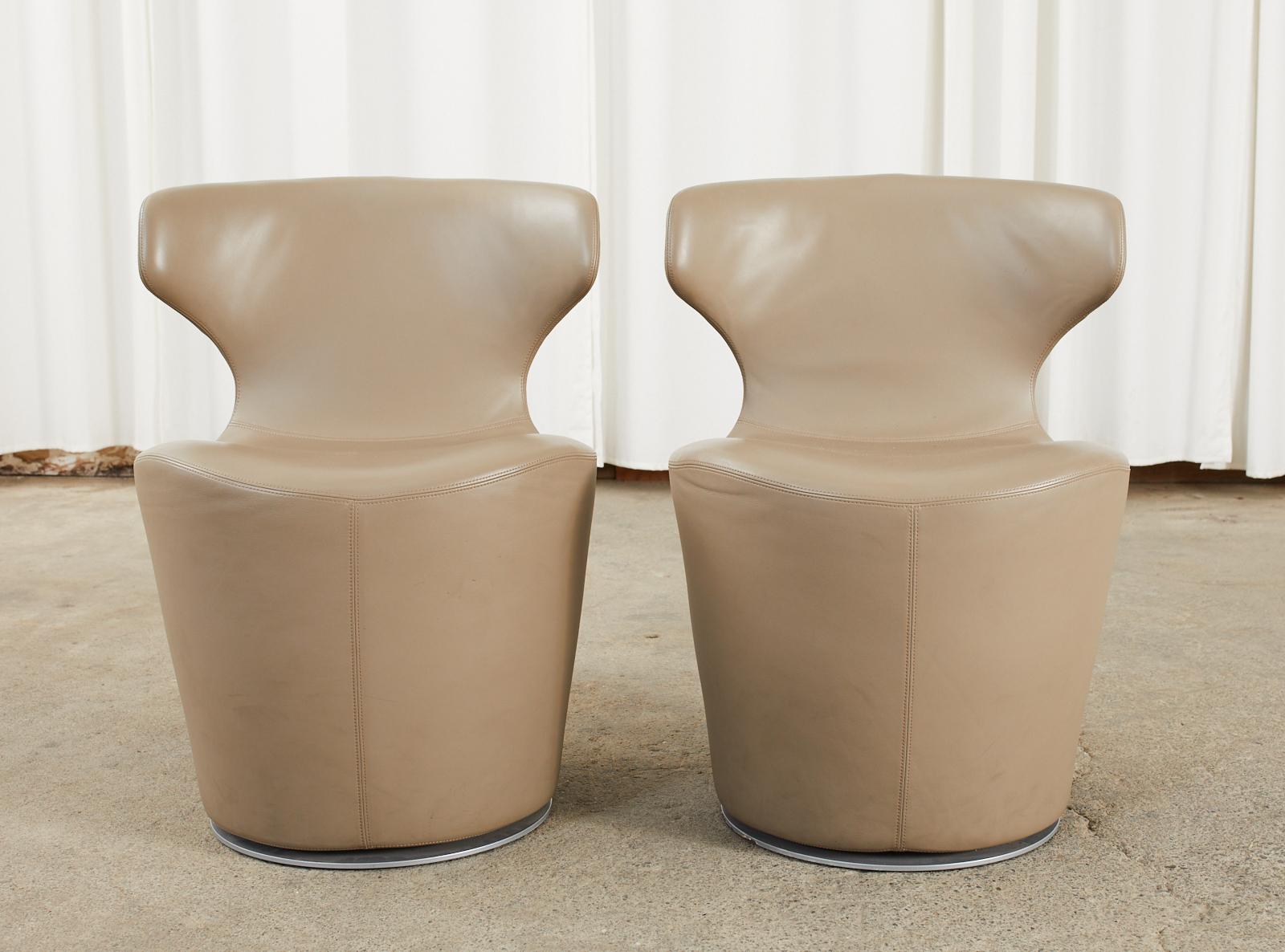 Sleek pair of leather mini Papilio chairs designed by Naoto Fukusawa for B & B Italia. Amazing swivel chairs featuring a steel frame covered in fine Italian leather in an oyster tone with a steel swivel base. Iconic style with graceful lines and