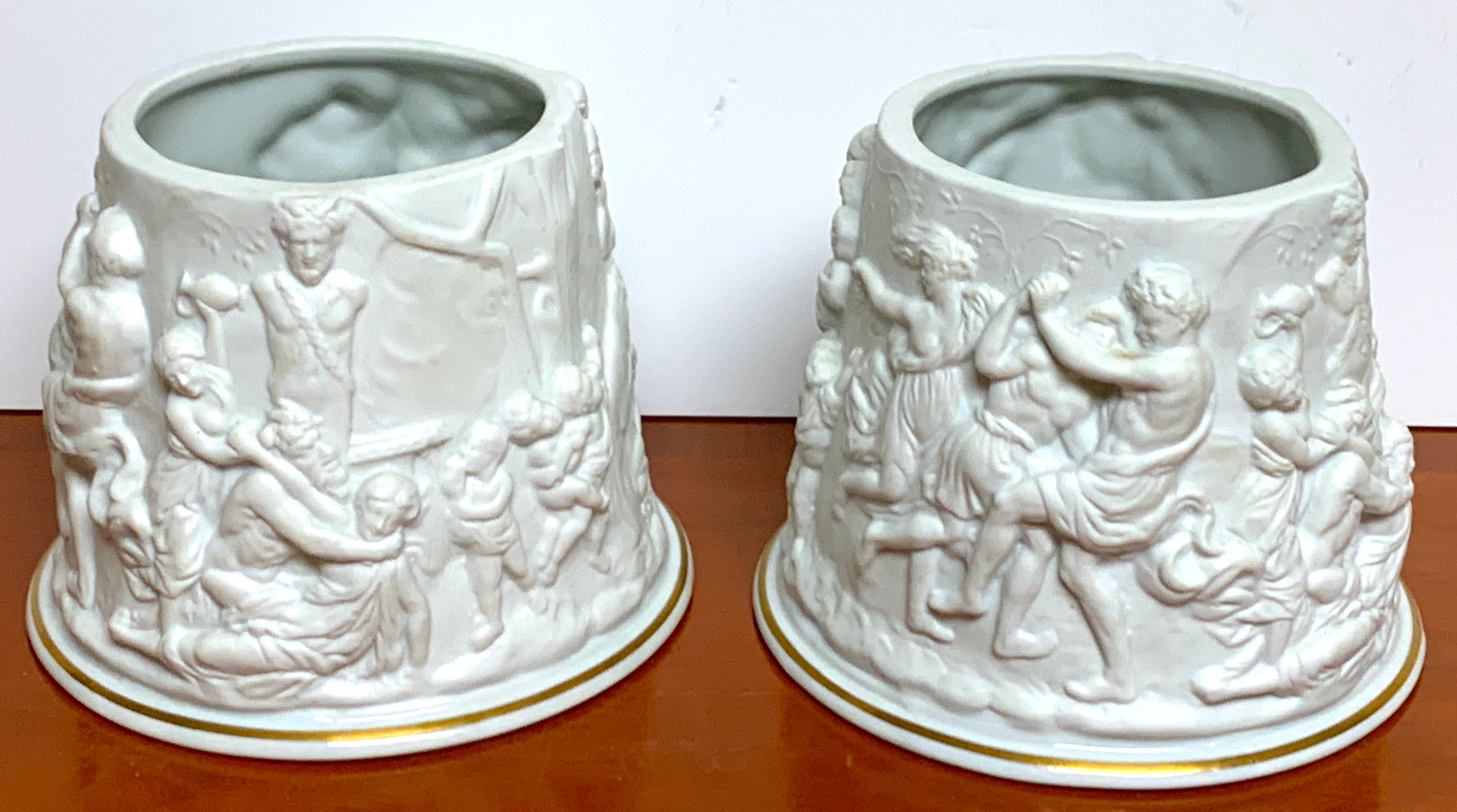 Pair of Naples/Capodimonte Porcelain Blanc de Chine Bacchanalian Cachepots, each one with a 4
