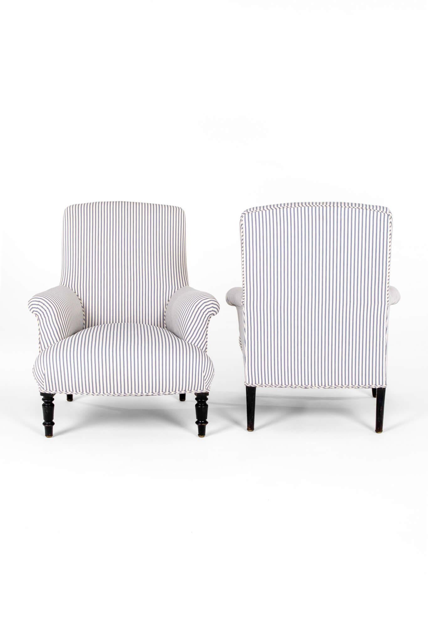 A wonderful pair of 19th century French Napoleon III square back armchair with a low back and a wide generous seat.

The walnut frames are raised on turned ebony legs.

This pair of armchairs has been fully restored and stripped back to the solid