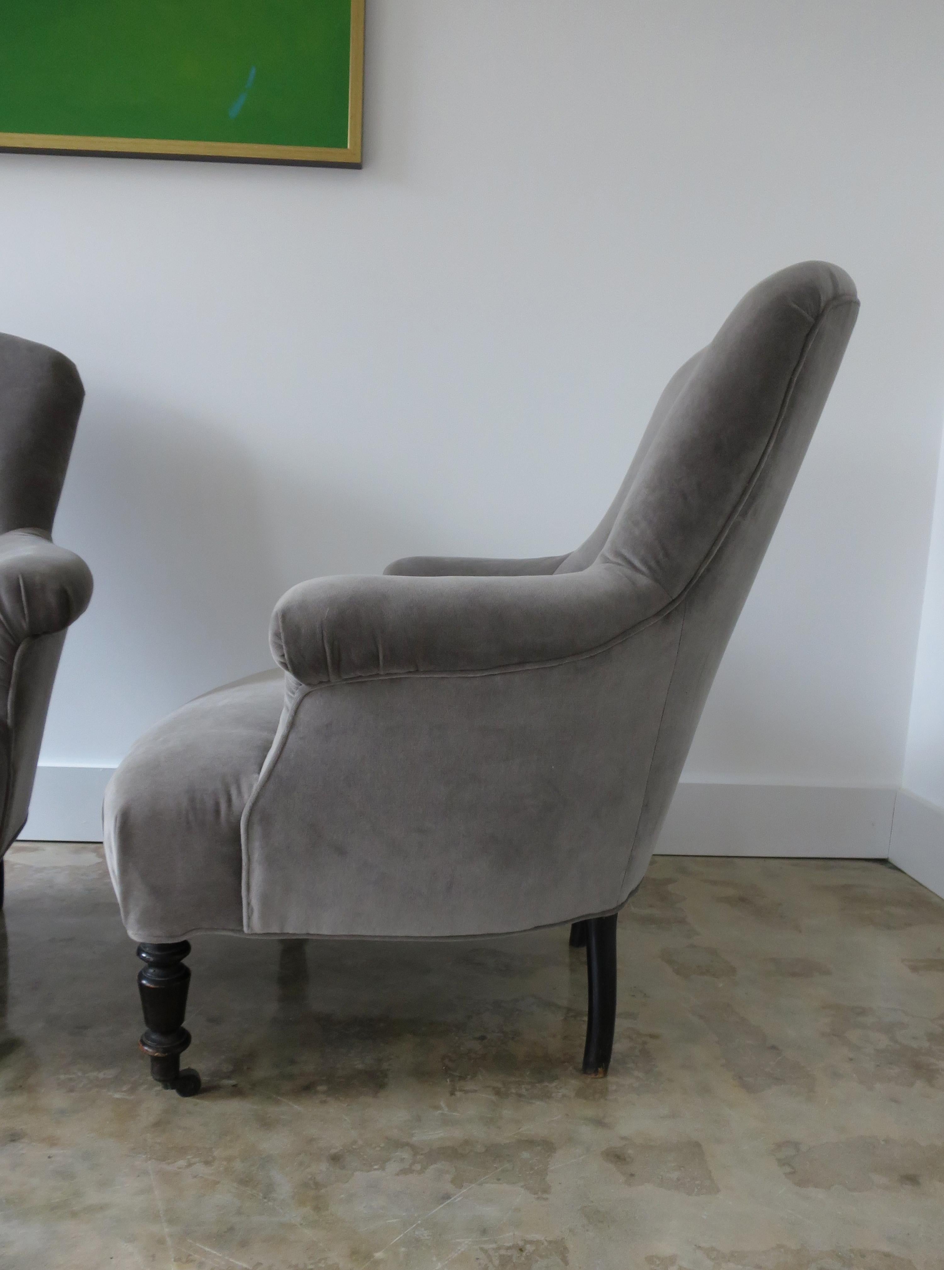 Late 19th century pair of Napoleon III armchairs completely redone, glued, reupholstered in sophisticated grey velvet. All important original blackened legs with original casters.