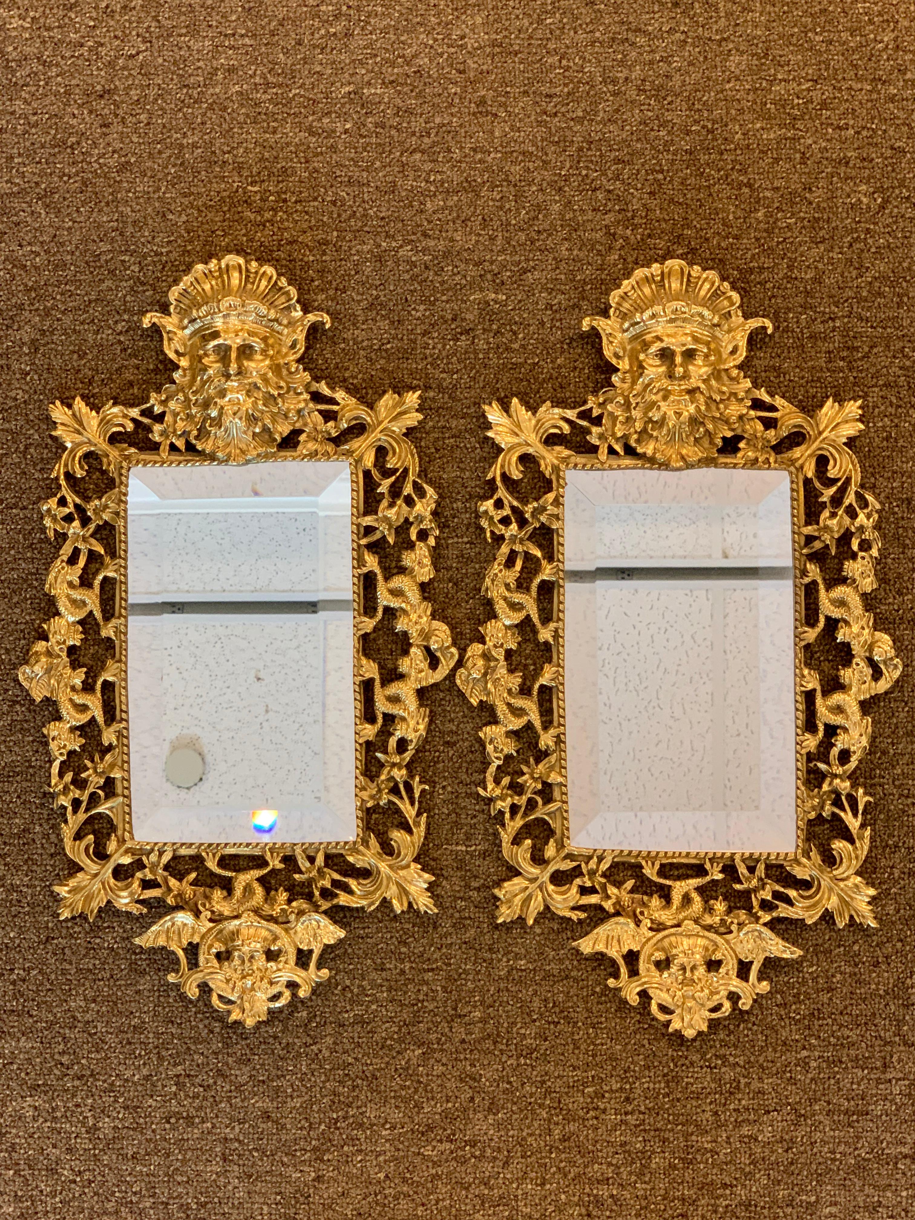 Pair of Napoleon III brass Neptune motif mirrors, each one fitted with a beveled 5