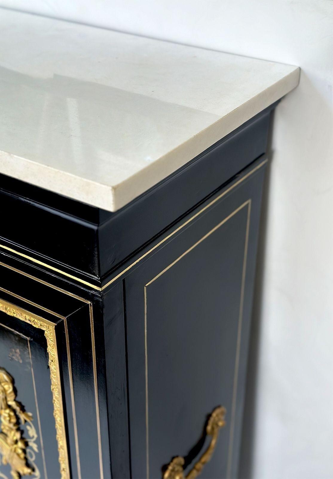 A pair of traditional cabinets in the manner of Mathieu Béfort with an ebonized wood frame that are decorated with figural gilt bronze mounts, depicting male and female figures, along with botanical motifs. Made in France, c. 1900's. It has an added