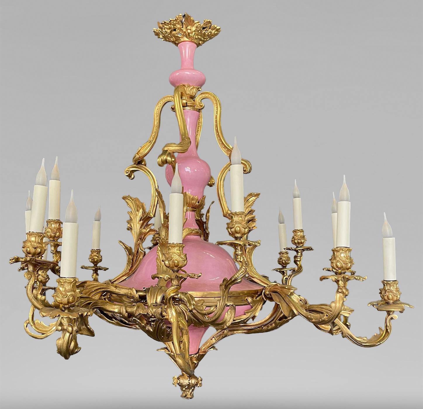 These blue and pink chandeliers are made in gilt bronze and porcelain and form a very special pair, characteristic of the decorative art under Napoleon III in late 19th century. The central porcelain shaft is composed of three balusters, which are