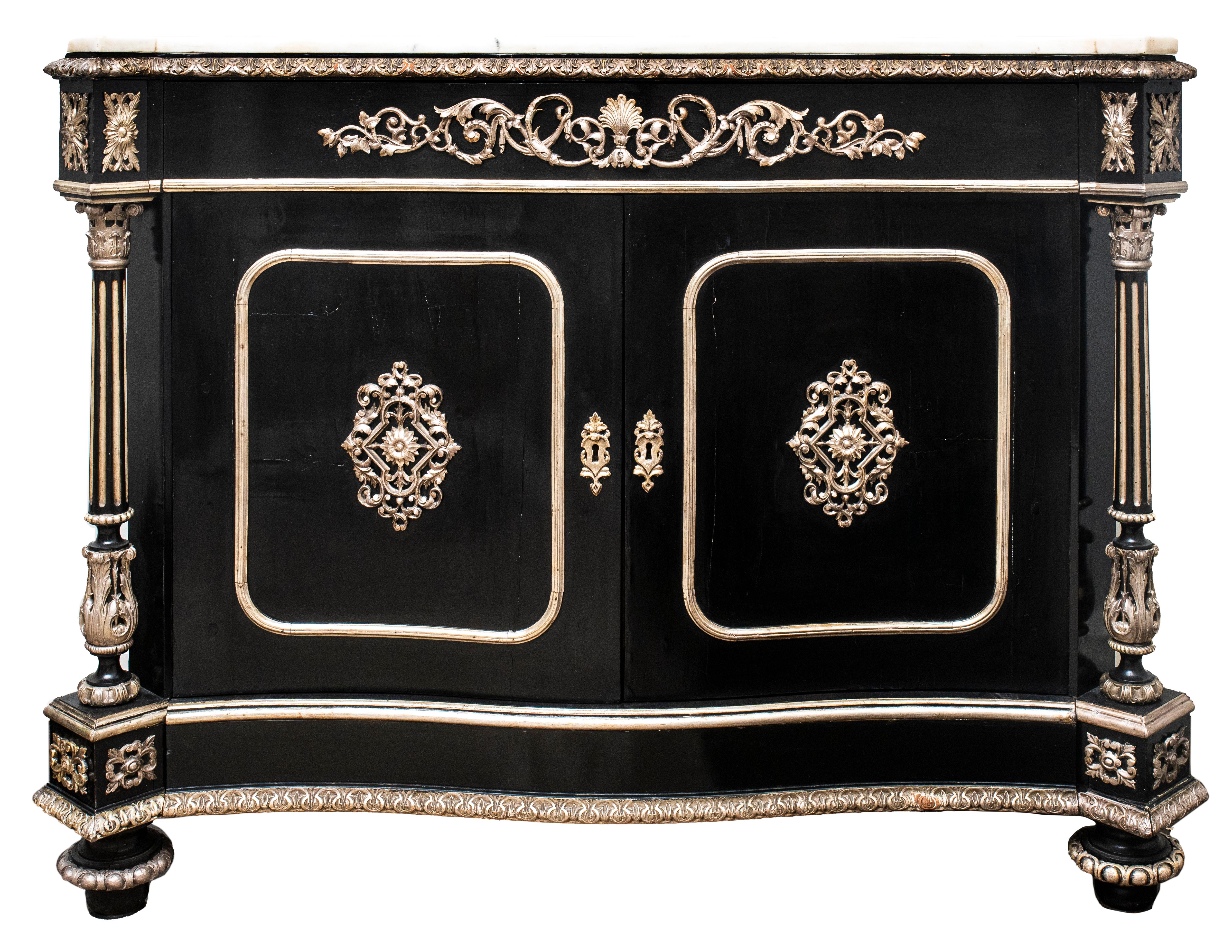 Napoleon III French Second Empire pair of monumental ebonized and parcel silvered meuble d'appui cabinets, each with white marble top, long drawer over pair of doors opening up to three interior burlwood drawers, flanked by fluted columns. Priced