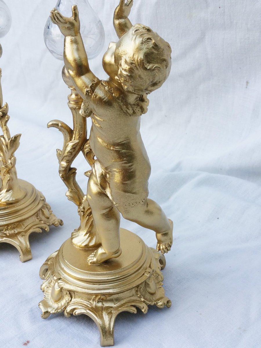 Elegant pair of vases soliflore or pike flower vases in gilt regule material used to replace bronze. One vase is representing a young boy and the other an older girl with longer hair, well dressed in a lovely dress both holdind crystal vases on a