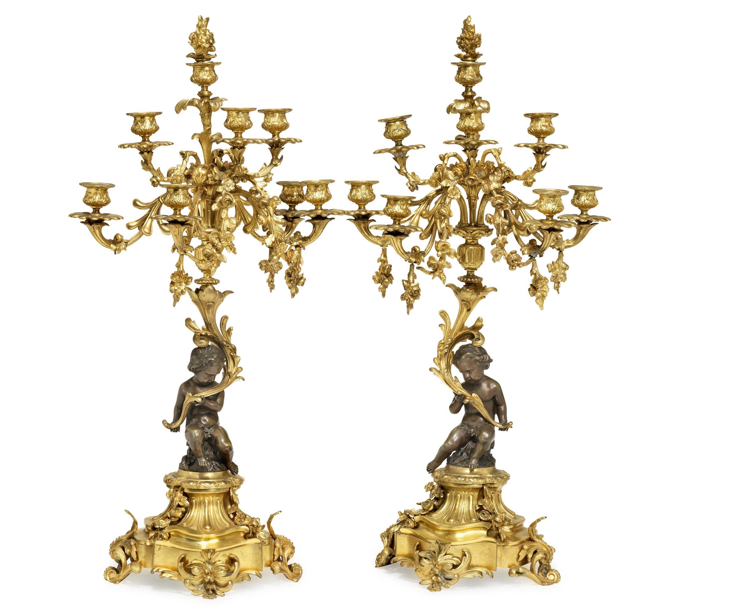A pair of Napoleon III gilt and patinated bronze eight-light candelabre, each with sitting putto. France, late 19th century. 

Measures: H. 74 cm.