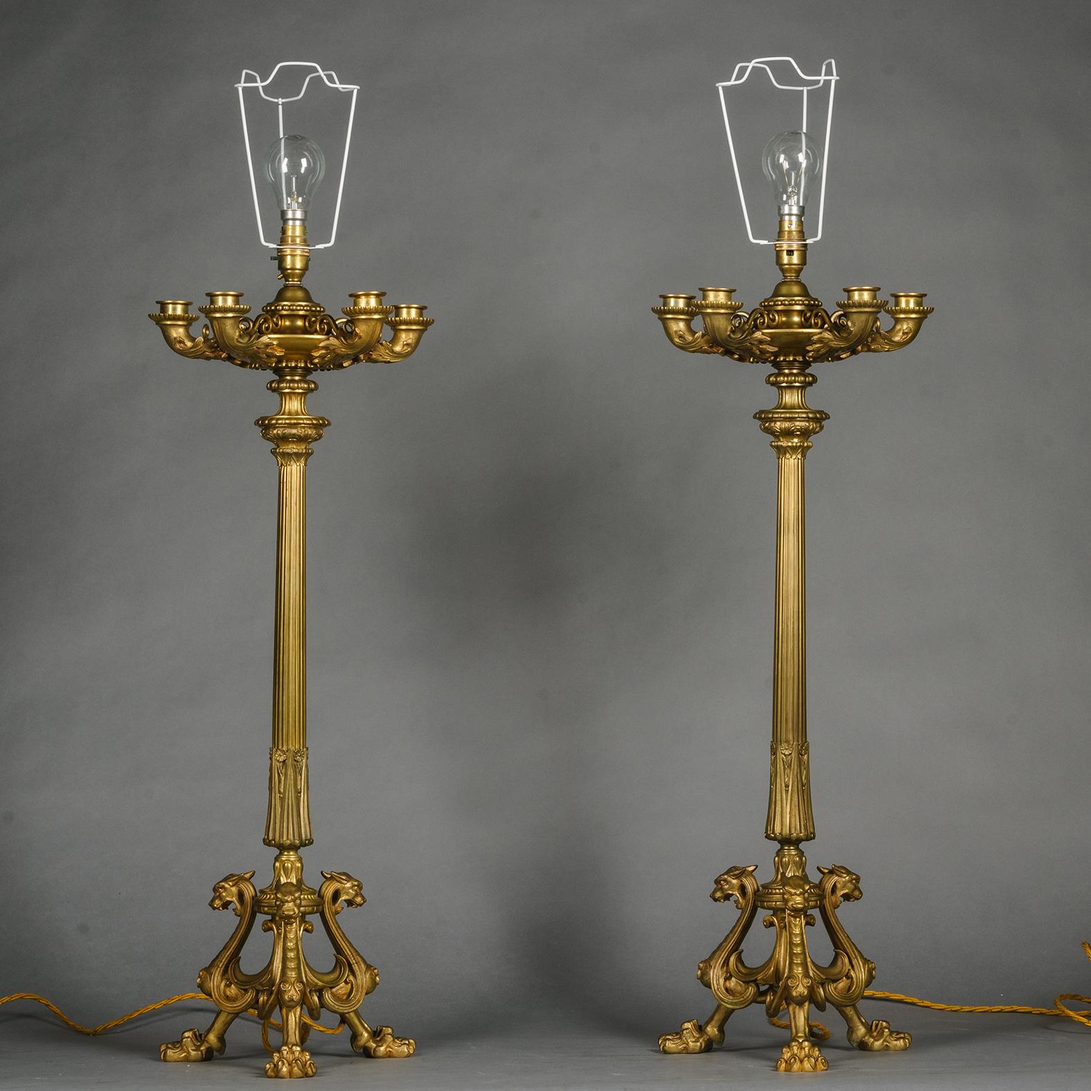 A Pair of Napoleon III Gilt-Bronze Five-Light Candelabra, Fitted As Lamps. 

Designed in the Neo-Grec style with three chimera modelled feet supporting a fluted stem and oil-lamp like body with four candle arms and a central nozzle with bulb
