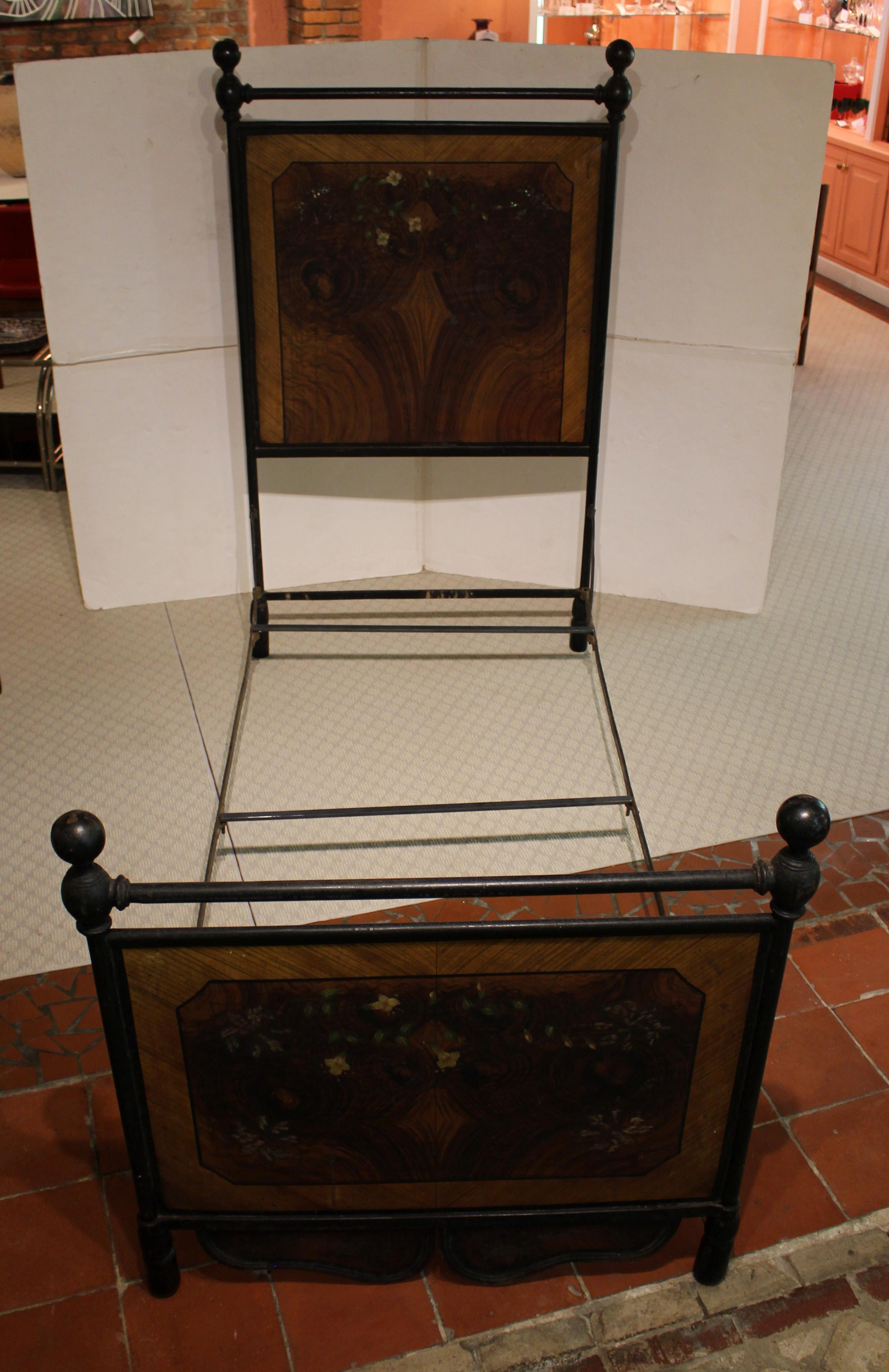 3rd quarter 19th century pair of French tole & iron single beds. Napoleon III period. Superb faux bois walnut & satinwood paintwork on the head & foot boards inlaid with mother of pearl accents & asymetrically painted with vining flowers. Note the